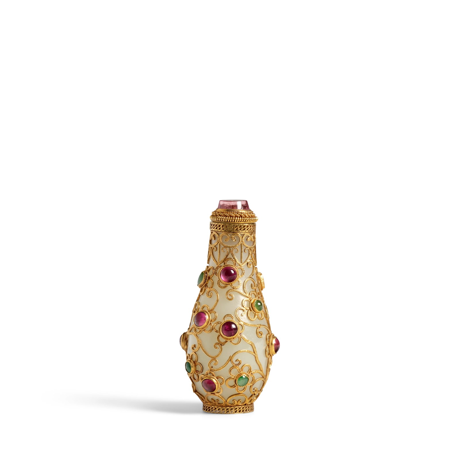A GILT AND CABUCHON-MOUNTED WHITE JADE SNUFF BOTTLE 1850-1940: A GILT AND CABUCHON-MOUNTED WHITE JADE SNUFF BOTTLE 1850-1940 The tapered pear-shaped bottle with flat rim and small mouth enclosed in a gilt wire and multi-colored glass mounted floral-form network c