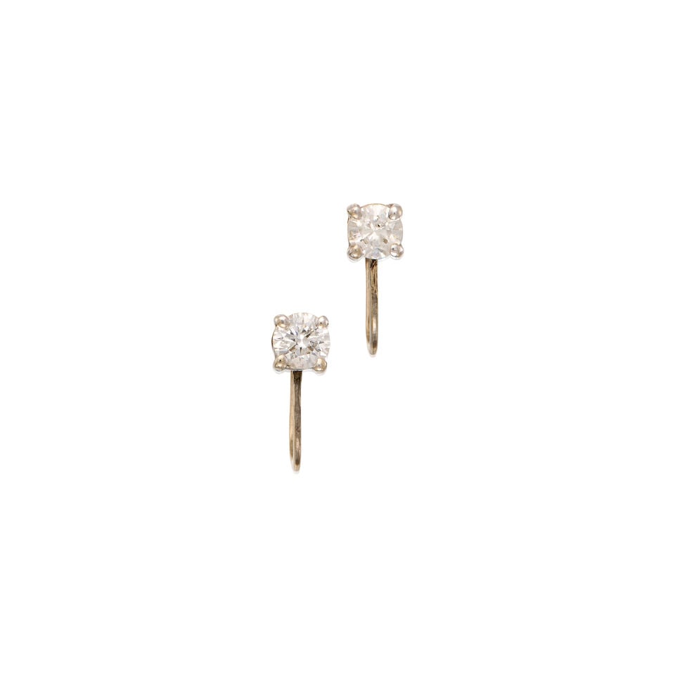 A WHITE GOLD AND DIAMOND EARRINGS: A WHITE GOLD AND DIAMOND EARRINGS • 12K and 13K white gold • Two round brilliant-cut diamonds weighing approximately 0.66 carat total • Measures 1/2 in. x 1/2 in. • Estimated