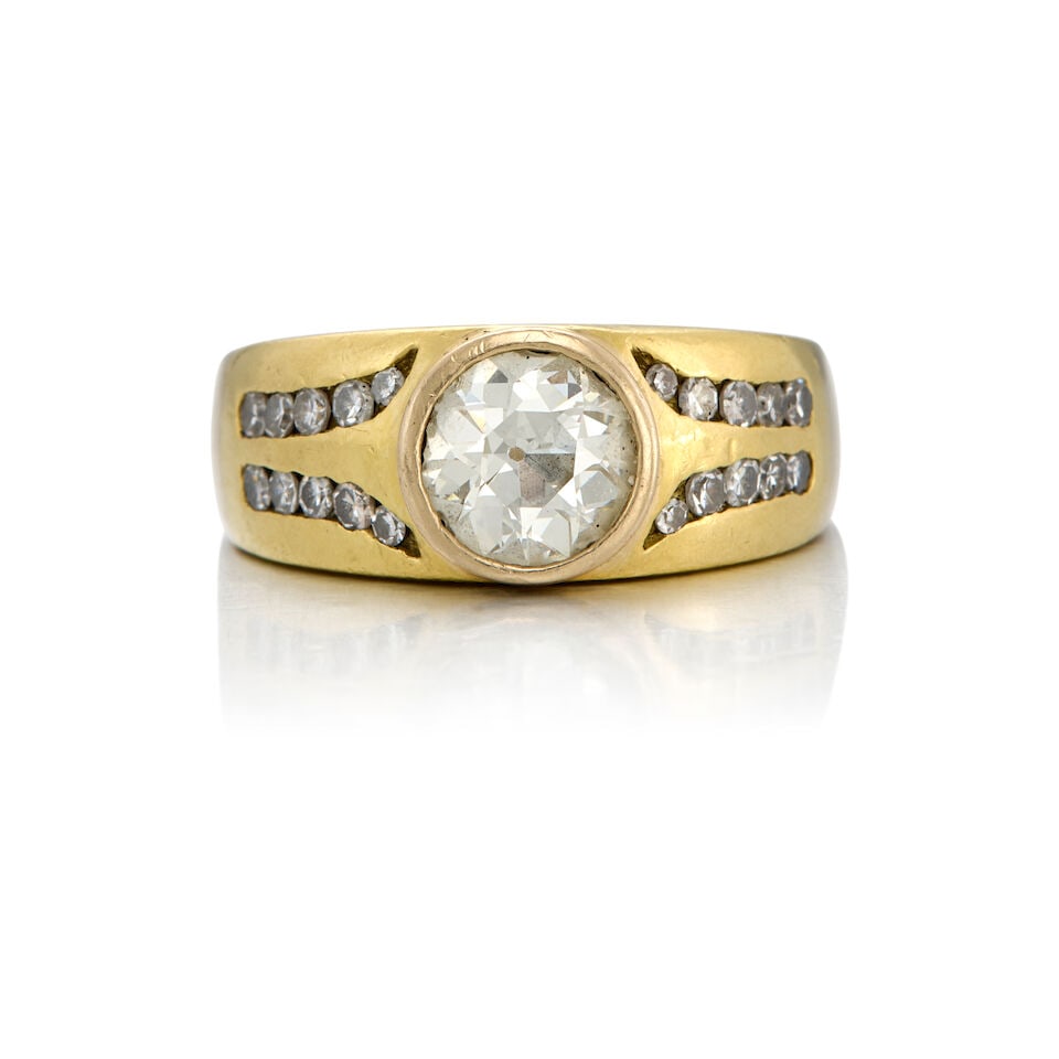 A GOLD AND DIAMOND RING: A GOLD AND DIAMOND RING • 16K and 18K yellow gold • One old european-cut diamond weighing approximately 2.06 carats • Twenty round single cut diamonds weighing approximately 0.80 car