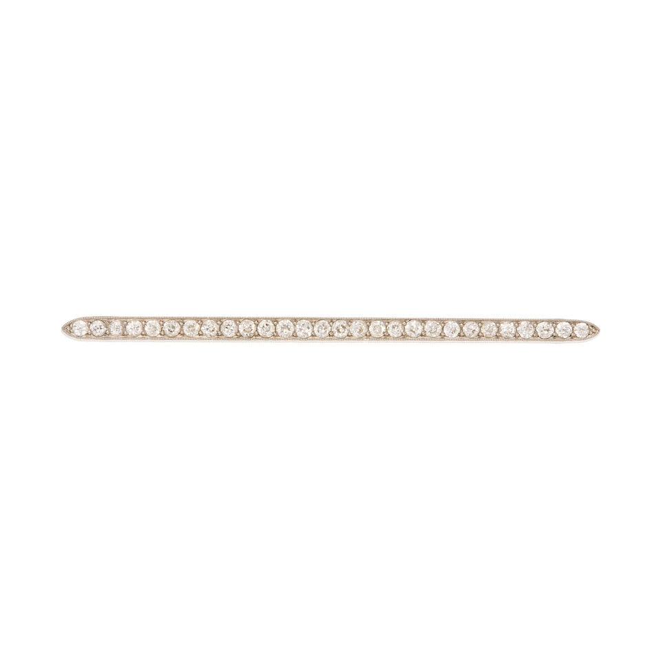 AN ANTIQUE PLATINUM AND DIAMOND BAR BROOCH: AN ANTIQUE PLATINUM AND DIAMOND BAR BROOCH • Twenty-eight european-cut diamonds weighing approximately 2.35 carats total • Measures 2 3/8 in. x 1/4 in. • Estimated gross weight: