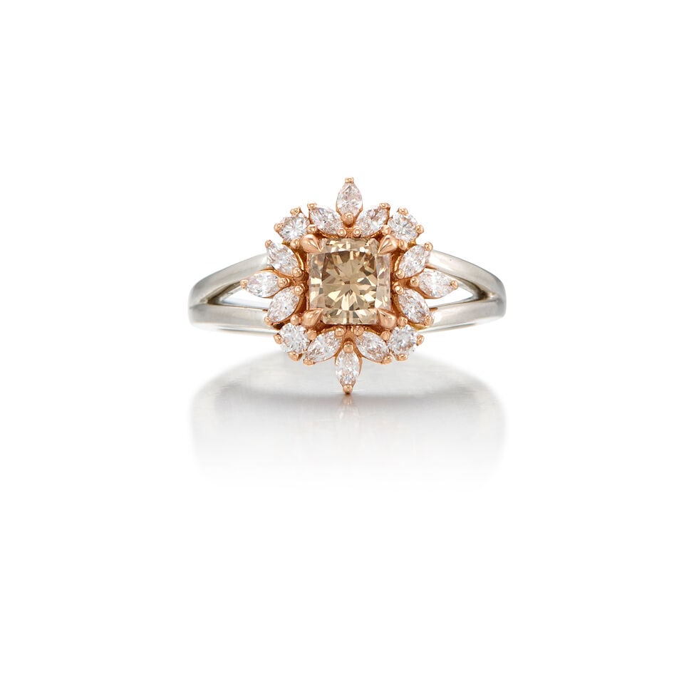 A GOLD AND DIAMOND RING: A GOLD AND DIAMOND RING • Platinum and 13K rose gold • One square-shaped diamond weighing approximately 0.72 carat • Twelve marquise- shaped diamonds weighing approximately 0.42