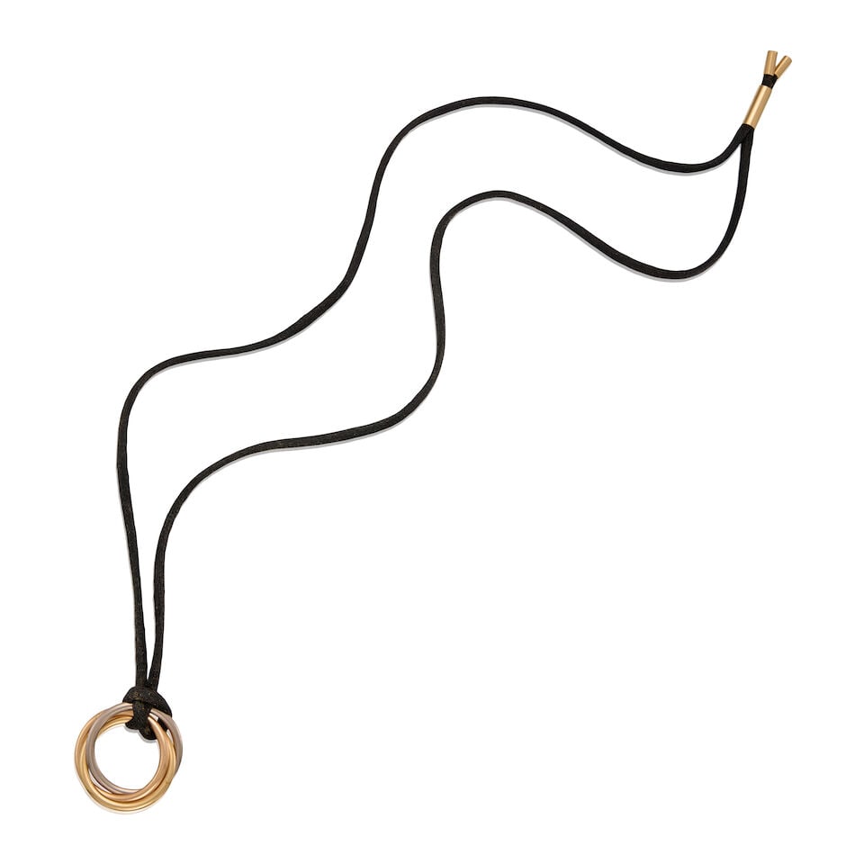 CARTIER: A GOLD TRINITY CORD NECKLACE: CARTIER: A GOLD TRINITY CORD NECKLACE • 18K yellow and white gold trinity pendant, measures 1 in. x 1 in., • 18K yellow gold and black cord necklace, wearable length 23 in. •