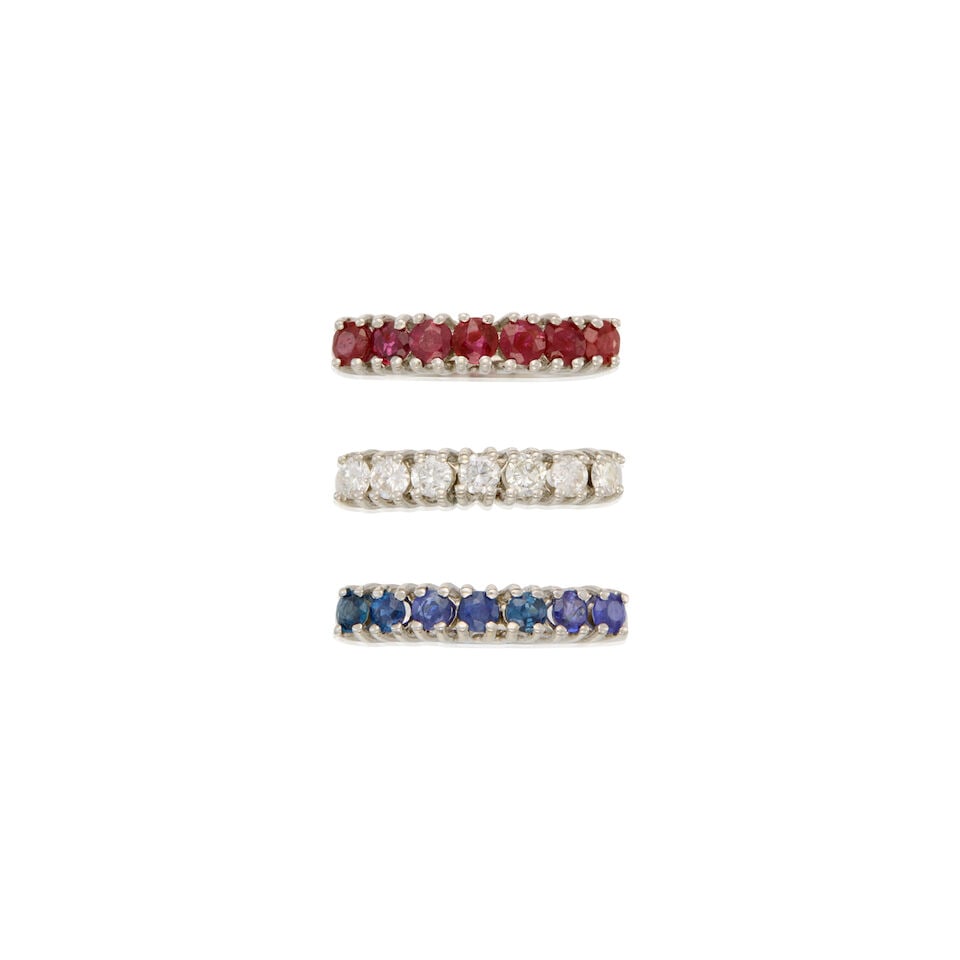 A GROUP OF THREE WHITE GOLD, RUBY, SAPPHIRE AND DIAMOND RINGS: A GROUP OF THREE WHITE GOLD, RUBY, SAPPHIRE AND DIAMOND RINGS • A 16K and 18K white gold ring with seven round-shaped rubies weighing approximately 1.05 carats total, size 7 1/4 • A 16K