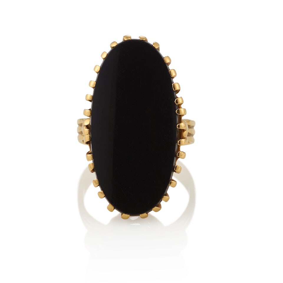 12K GOLD AND ONYX RING: 12K GOLD AND ONYX RING • 12K yellow gold • One oval shaped onyx measuring approximately 27.9mm x 14.96mm x 7.20mm • Size 8 1/4 • Estimated gross weight: 11.2 grams Footnotes: O