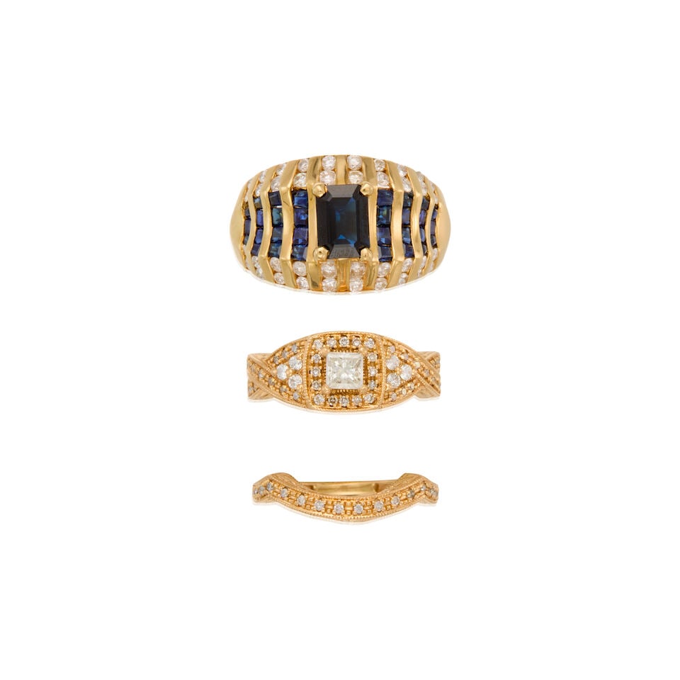 A GROUP OF THREE GOLD, SAPPHIRE AND DIAMOND RINGS: A GROUP OF THREE GOLD, SAPPHIRE AND DIAMOND RINGS • A 14K gold ring with one rectangular-shaped sapphire weighing approximately 0.90 carat, thirty square and tapered baguette sapphires weighing
