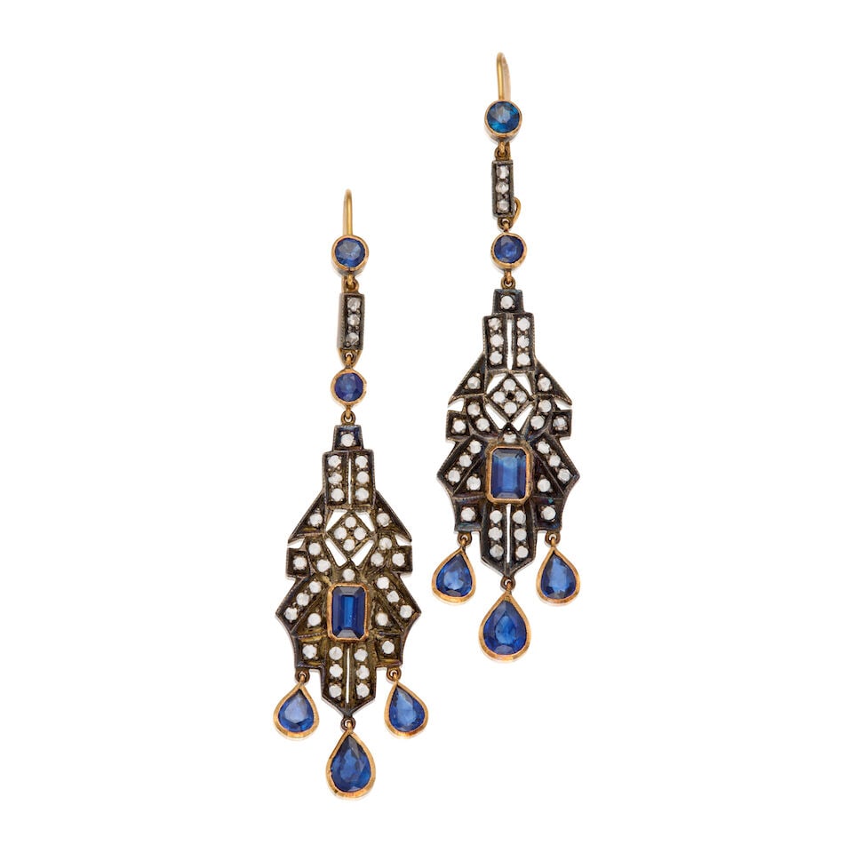 SAPPHIRE AND DIAMOND DROP EARRINGS: SAPPHIRE AND DIAMOND DROP EARRINGS • 18K gold and silver • Four round-shaped, two emerald-shaped, six pear-shaped sapphires weighing approximately 4.38 carats total • Numerous