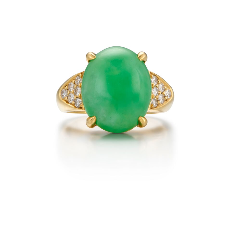 GUMPS: 18K GOLD, JADE AND DIAMOND RING: GUMPS: 18K GOLD, JADE AND DIAMOND RING • One oval cabochon-shaped jade weighing approximately 9.82 carats • Twelve round brilliant-cut diamonds weighing approximately 0.24 carat total R