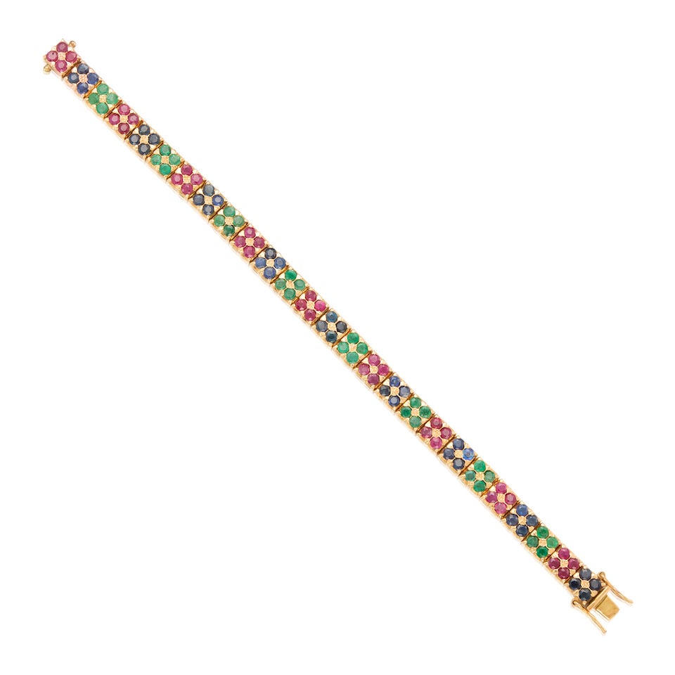 A 14K GOLD, RUBY, EMERALD, SAPPHIRE AND LATTICE DIFFUSION SAPPHIRE BRACELET: A 14K GOLD, RUBY, EMERALD, SAPPHIRE AND LATTICE DIFFUSION SAPPHIRE BRACELET • Thirty-six round-shaped rubies weighing approximately 3.89 carats total • Thirty-two round-shaped emeralds