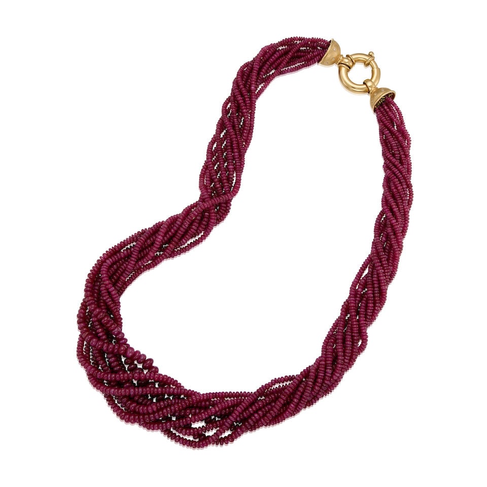 AN 18K GOLD AND RUBY MULTISTRAND NECKLACE: AN 18K GOLD AND RUBY MULTISTRAND NECKLACE • Ten strands of numerous round-shaped ruby drilled beads measuring approximately 2.48mm to 7.23mm in diameter • Sixteen round single-cut diamonds