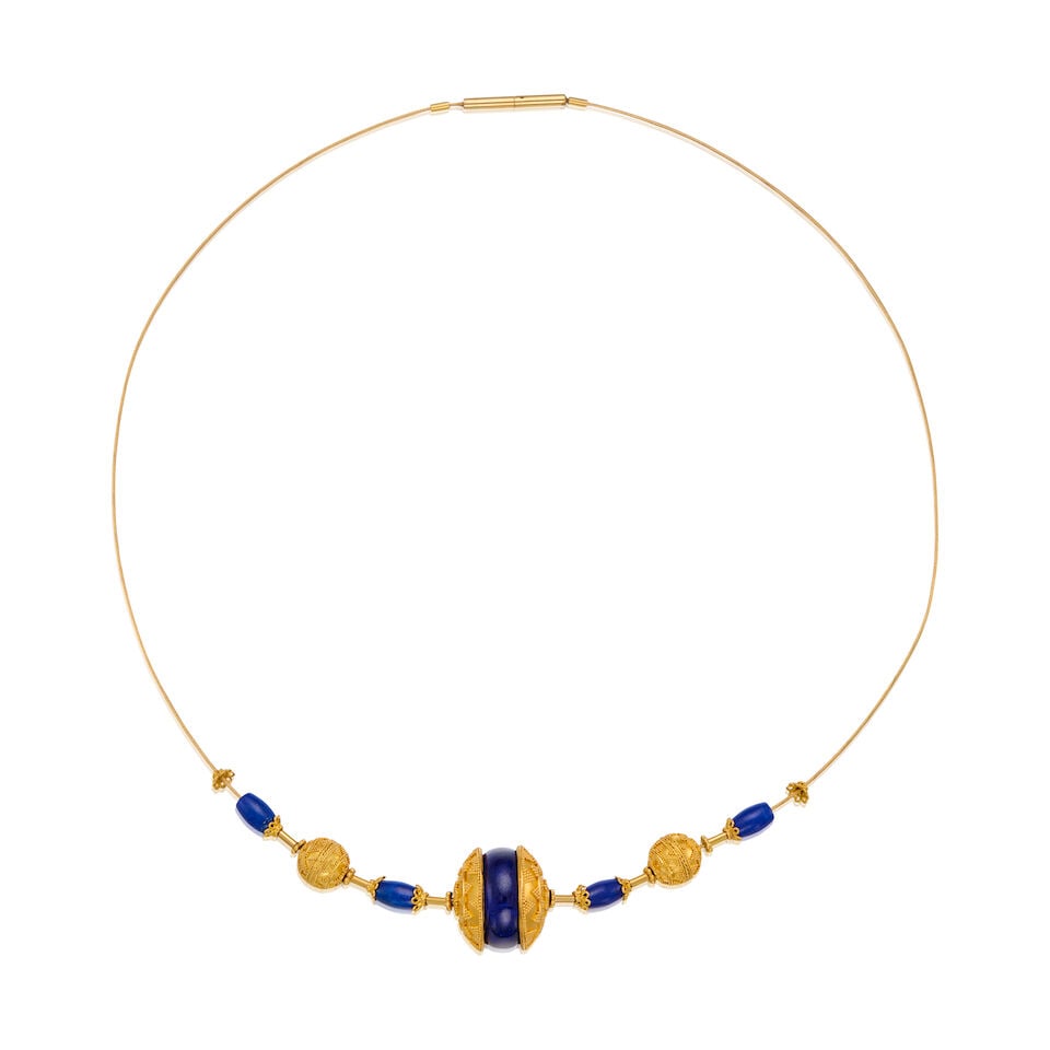 A GOLD AND LAPIS LAZULI COLLAR NECKLACE: A GOLD AND LAPIS LAZULI COLLAR NECKLACE • 18K and 20K gold • Five carved lapis lazuli measuring approximately 6.57mm x 4.15mm to 15.29mm in diameter • Length 15 1/2 in. •
