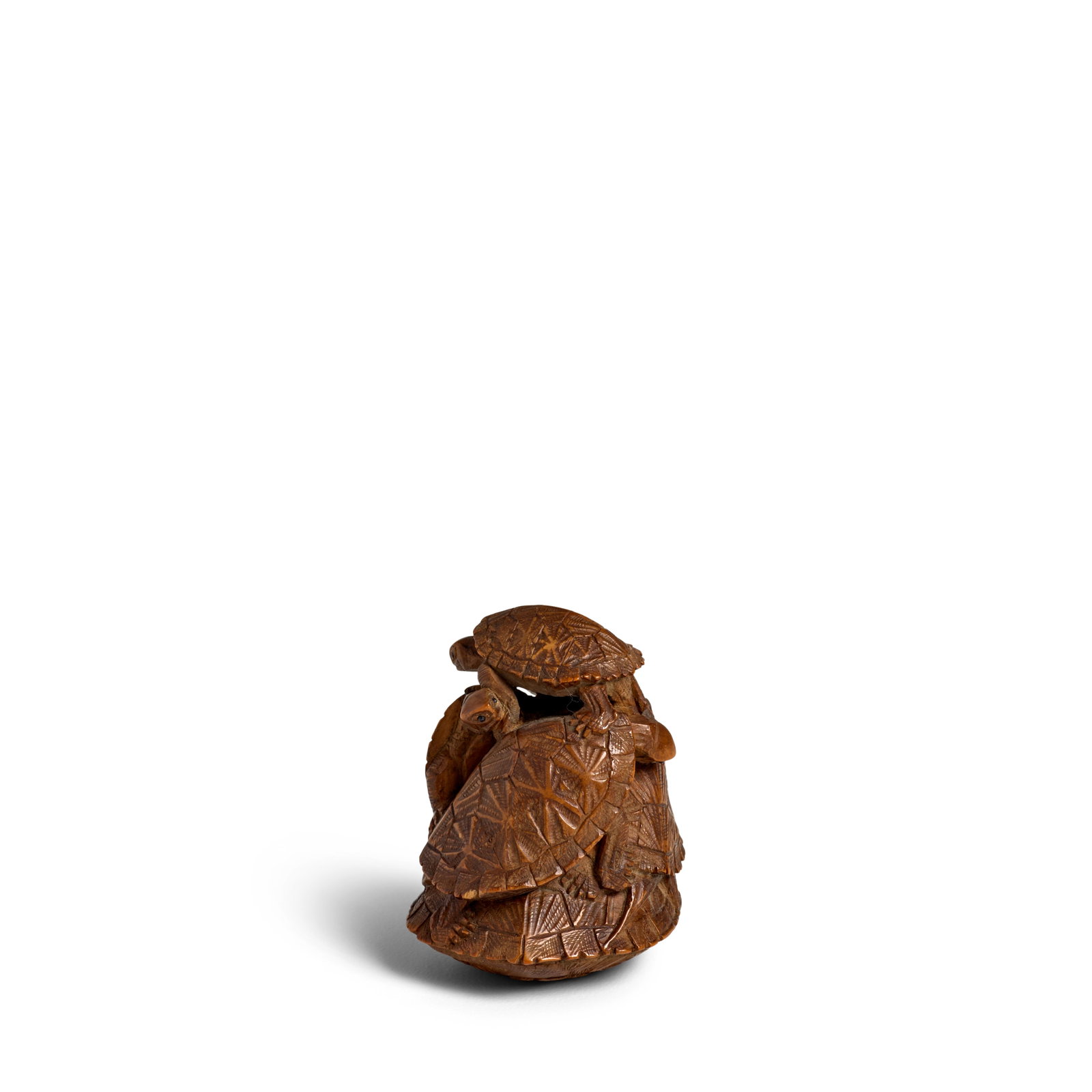 GEKKŌ (ACTIVE LATE 19TH CENTURY) A Wood Netsuke of a Pile of Turtles Meiji era (1868-1912),...: GEKKŌ (ACTIVE LATE 19TH CENTURY) A Wood Netsuke of a Pile of Turtles Meiji era (1868-1912), late 19th century Carved as a group of turtles clambering on top of one another, the himotoshi lined in