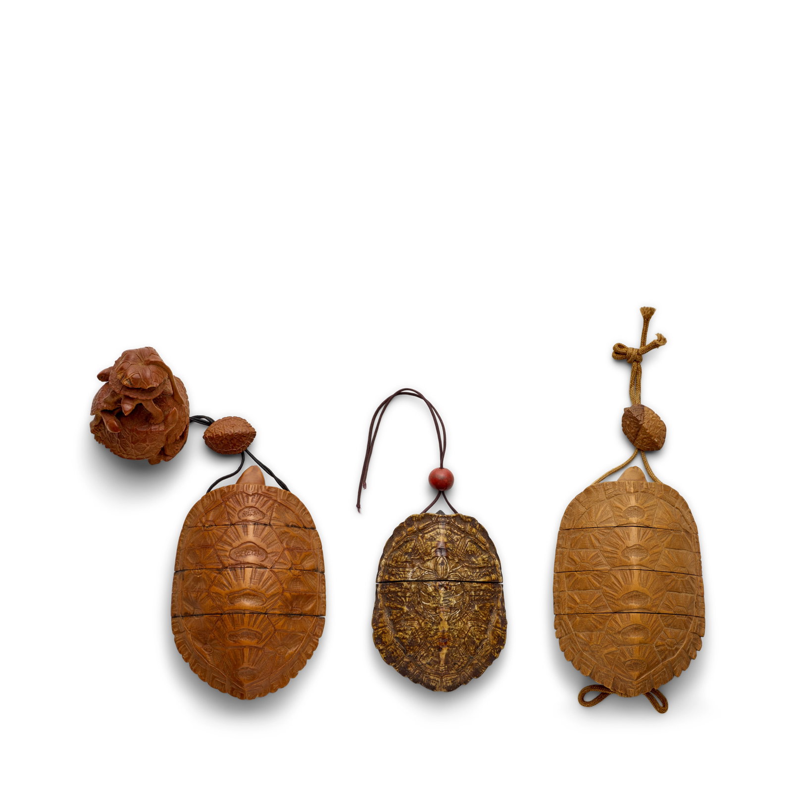 THREE CARVED-WOOD INRŌ (MEDICINE CONTAINERS) IN THE FORM OF TORTOISES Edo period (1615-1868...: THREE CARVED-WOOD INRŌ (MEDICINE CONTAINERS) IN THE FORM OF TORTOISES Edo period (1615-1868) or Meiji era (1868-1912), 19th century The first of three cases, signed Kōkaku, fitted with an oj
