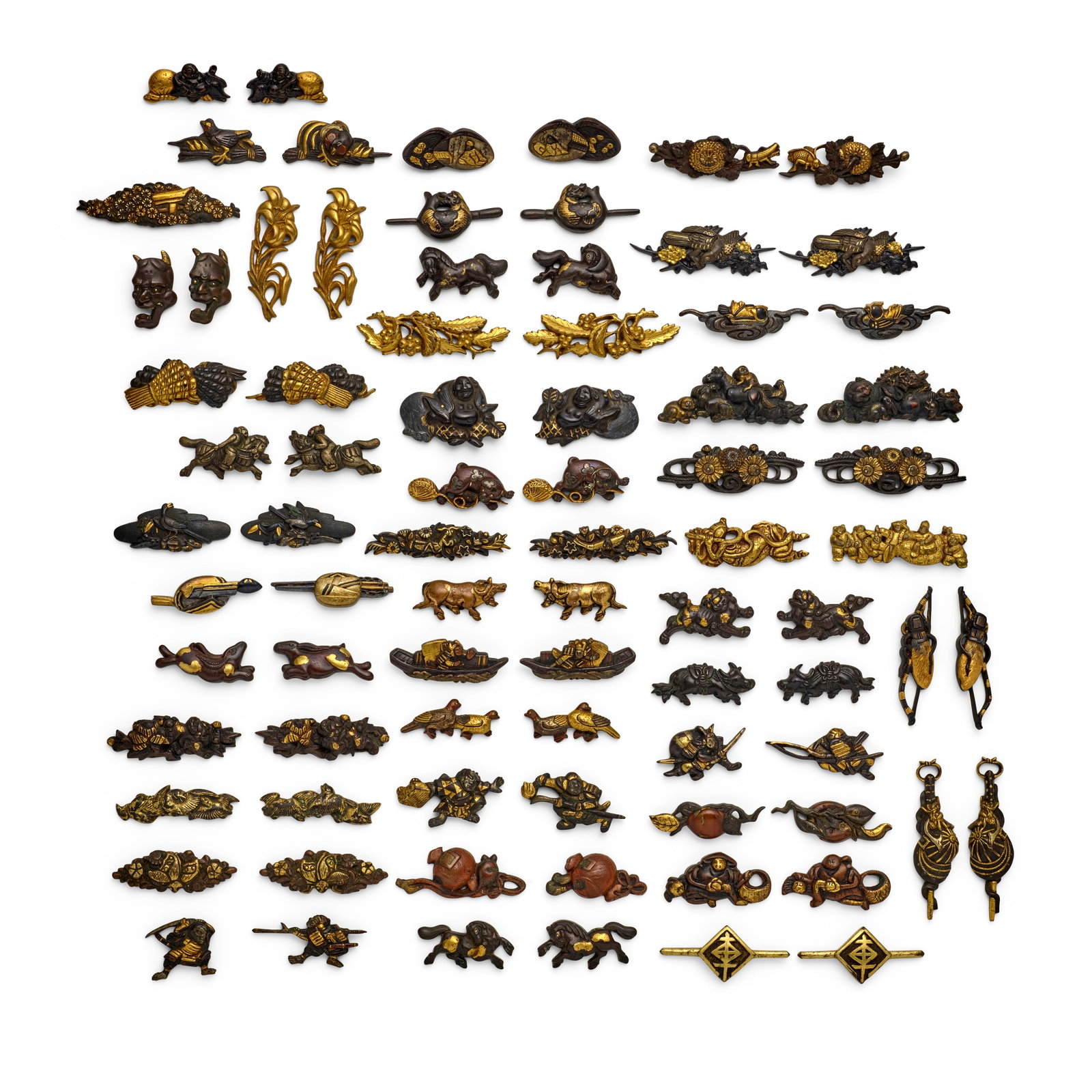 40 PAIRS OF MIXED-METAL MENUKI (HILT GRIPS) AND ONE SINGLE MENUKI Edo period (1615-1868), 18th/1...: 40 PAIRS OF MIXED-METAL MENUKI (HILT GRIPS) AND ONE SINGLE MENUKI Edo period (1615-1868), 18th/19th century Comprising a gold and shakudō pair in the form of frolicking shishi (mythical Chinese l