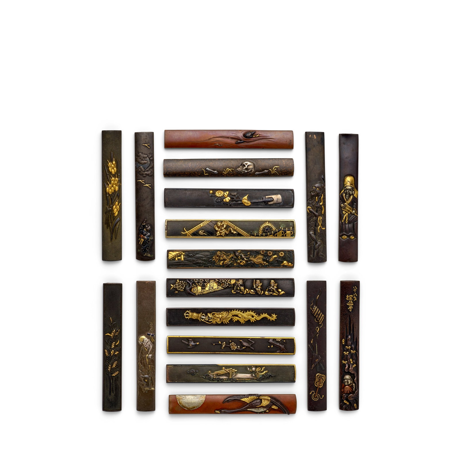 18 MIXED-METAL KOZUKA (KNIFE HANDLES) Edo period (1615-1868), 18th/19th century (18): 18 MIXED-METAL KOZUKA (KNIFE HANDLES) Edo period (1615-1868), 18th/19th century Comprising a shakudō nanako kozuka within a shibuichi frame inlaid in relief of gold and silverwith a dragon swallo