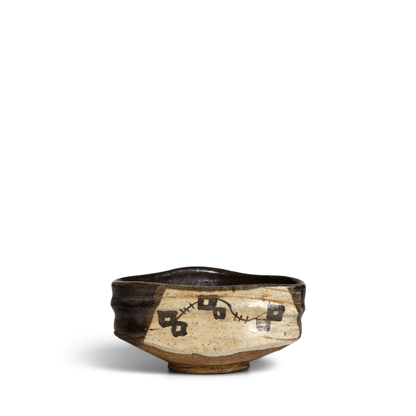 A KURO-ORIBE TYPE MINO-WARE CHAWAN (TEA BOWL) Edo period (1615-1868), 17th/18th century: A KURO-ORIBE TYPE MINO-WARE CHAWAN (TEA BOWL) Edo period (1615-1868), 17th/18th century Of kutsugata (shoe-shape) form, the walls of the chawan forming a rough rounded-corner-triangular mouth, the hip