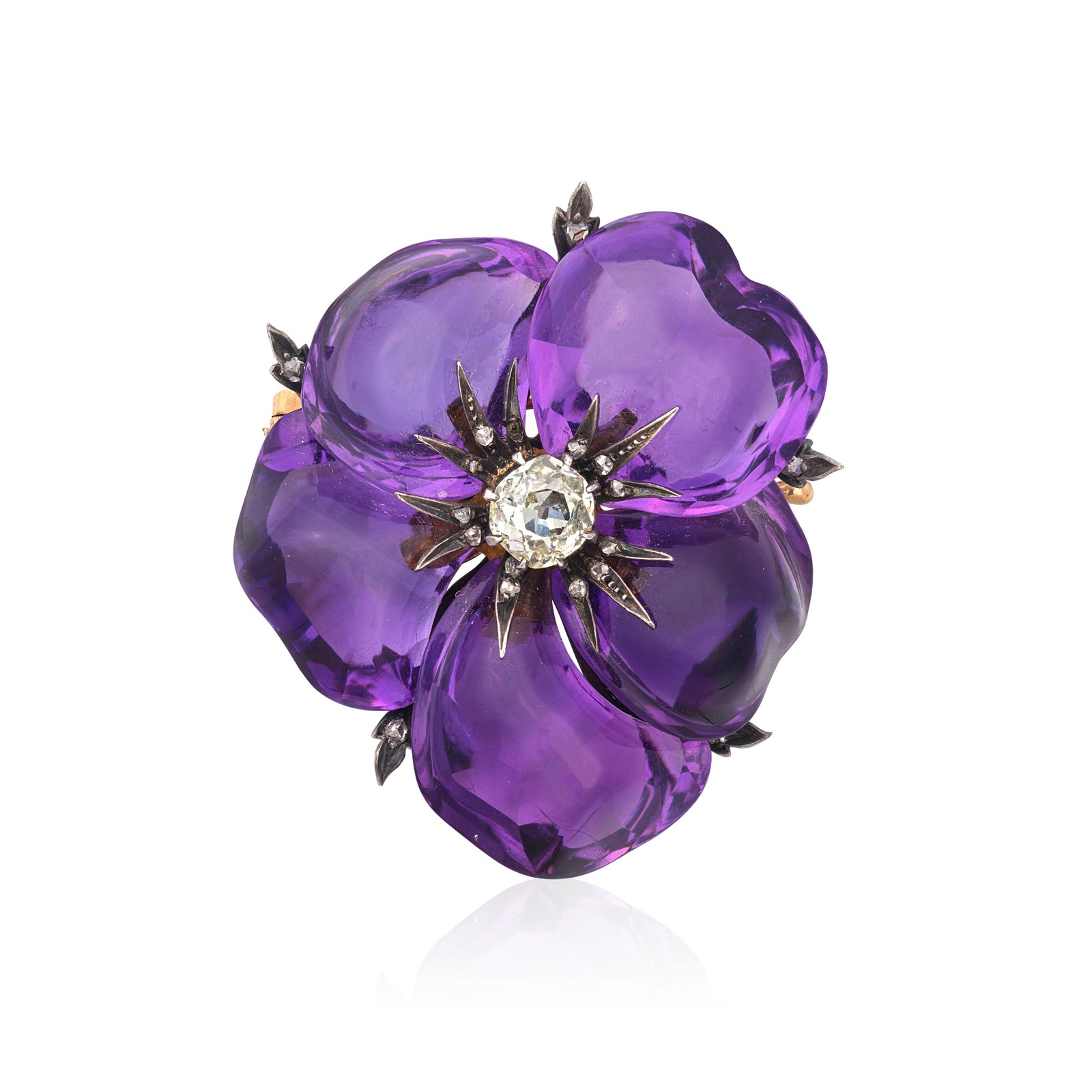 AMETHYST PANSY BROOCH, CIRCA 1880: AMETHYST PANSY BROOCH, CIRCA 1880 The amethyst naturalistically carved, centred by an old cushion-cut diamond, accented by rose-cut diamonds, one diamond deficient, length 3.8cm, cased by E. Schurmann