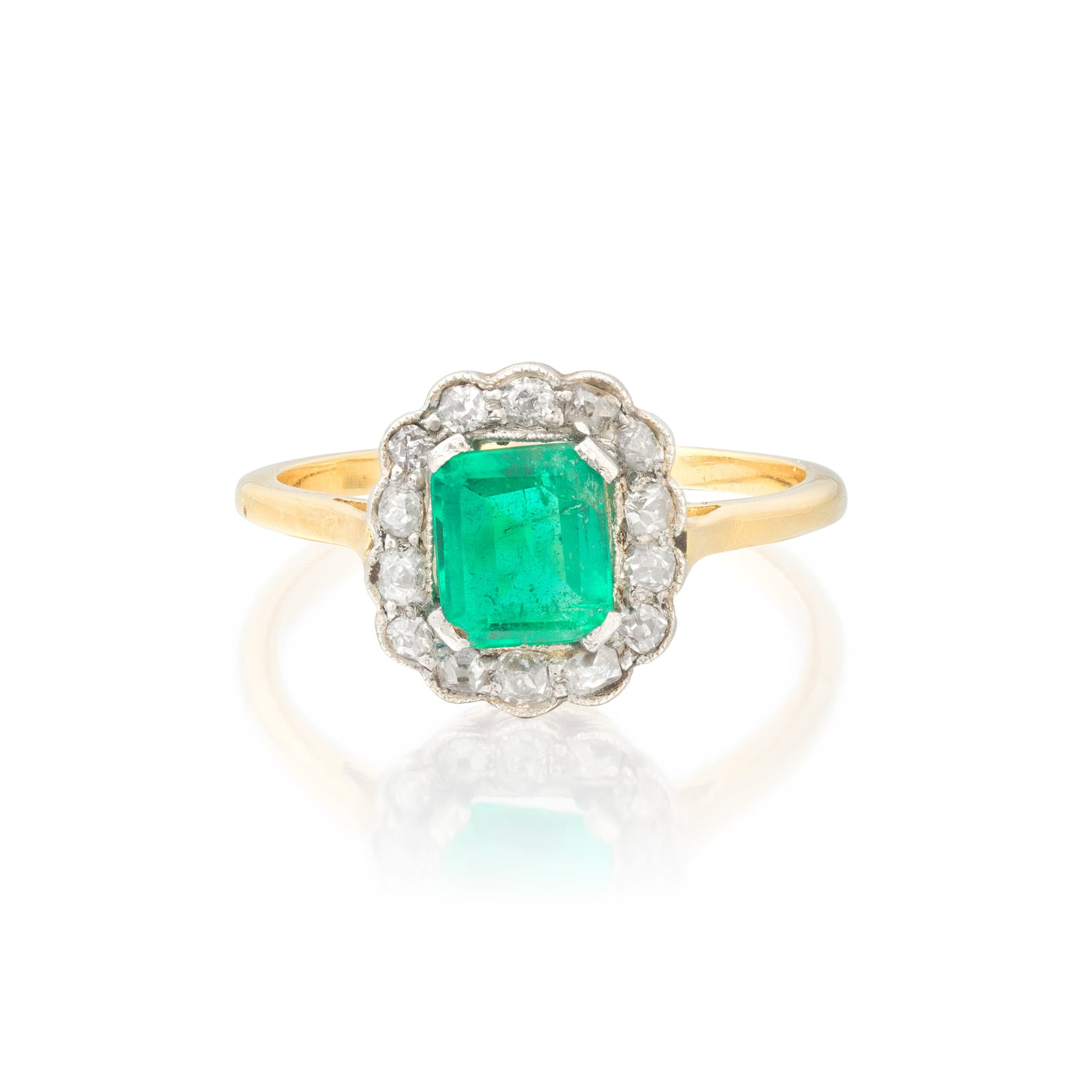 EMERALD AND DIAMOND RING: EMERALD AND DIAMOND RING The octagonal step-cut emerald within an old single-cut diamond surround, emerald approx. 0.70ct, ring size approx. M½ Footnotes: Jewellery From a Private Collection