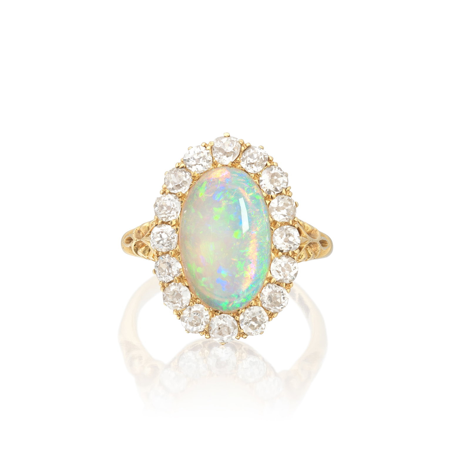 OPAL AND DIAMOND CLUSTER RING: OPAL AND DIAMOND CLUSTER RING The opal cabochon within an old cushion-cut diamond surround, between scrolled shoulders, diamonds approx. 1.15cts total, ring size approx. K Footnotes: Jewellery From a