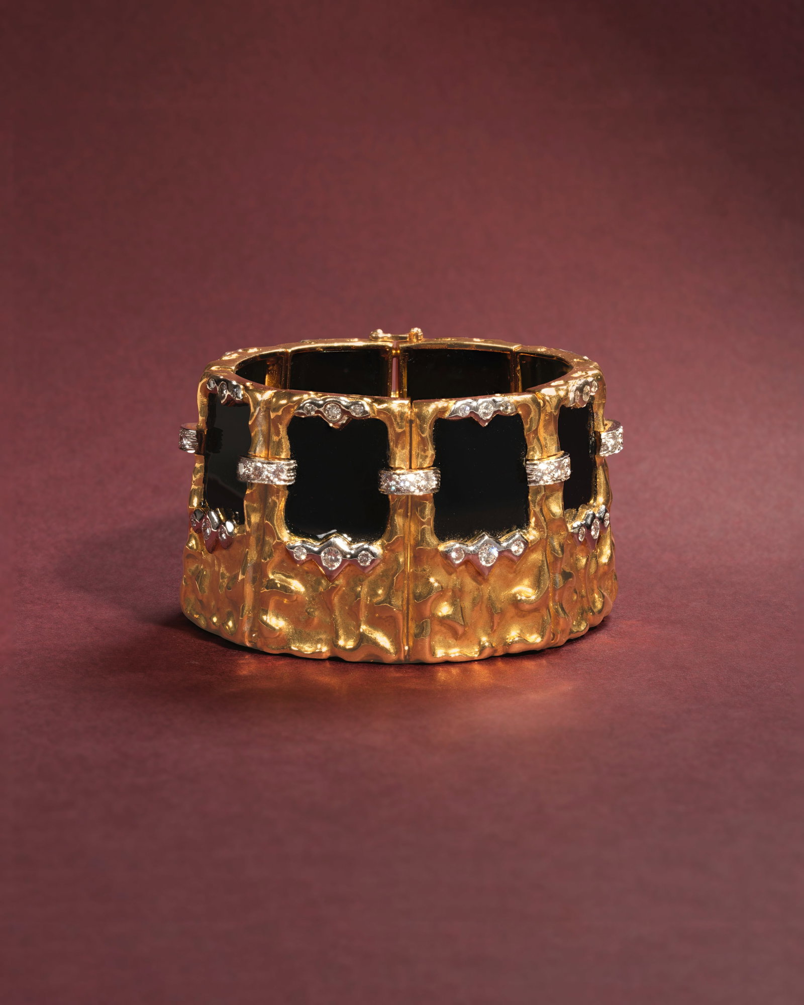KUTCHINSKY: ONYX AND DIAMOND BRACELET, 1972: KUTCHINSKY: ONYX AND DIAMOND BRACELET, 1972 Each 18 carat gold plaque of highly polished textured design, set with onyx and brilliant-cut diamonds, signed Kutchinsky, London hallmark, diamonds