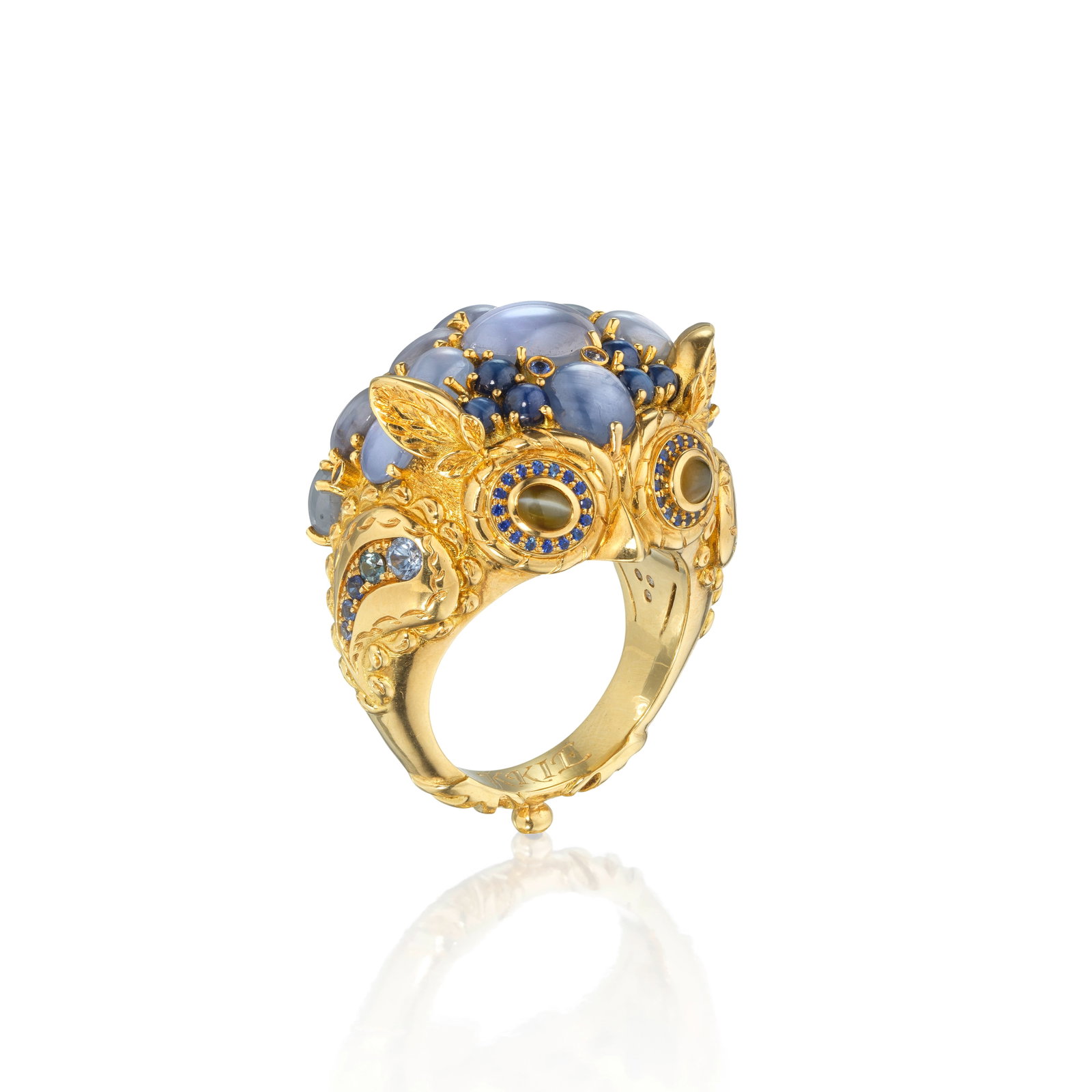 TEMPLE ST. CLAIR: GEM-SET OWL RING: TEMPLE ST. CLAIR: GEM-SET OWL RING Designed as an owl, the head of star sapphire cabochons, the eyes of cat's-eye chrysoberyls, accented throughout with circular-cut sapphires, maker's mark TSC, ring