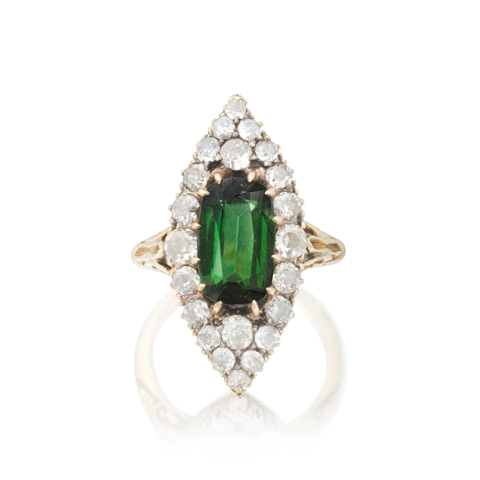 TOURMALINE AND DIAMOND NAVETTE RING, CIRCA 1900: TOURMALINE AND DIAMOND NAVETTE RING, CIRCA 1900 The cushion-cut tourmaline set within an old brilliant-cut diamond surround, to trifurcated shoulders of carved scroll detailing, mounted in gold,