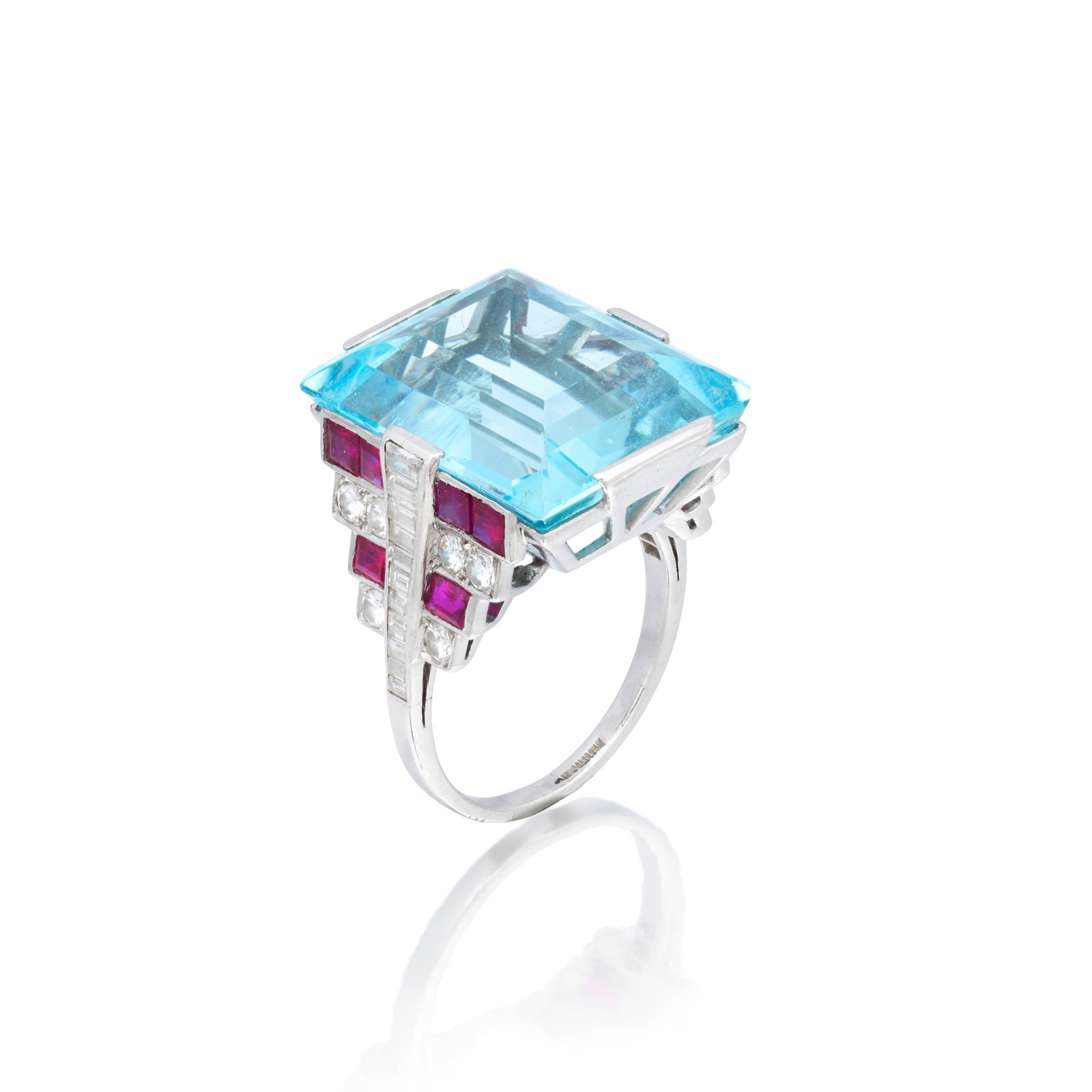 AQUAMARINE, RUBY AND DIAMOND RING: AQUAMARINE, RUBY AND DIAMOND RING The step-cut aquamarine set between calibré-cut rubies, baguette and brilliant-cut diamonds, aquamarine approx. 19.45cts, diamonds approx. 0.70ct total, ring