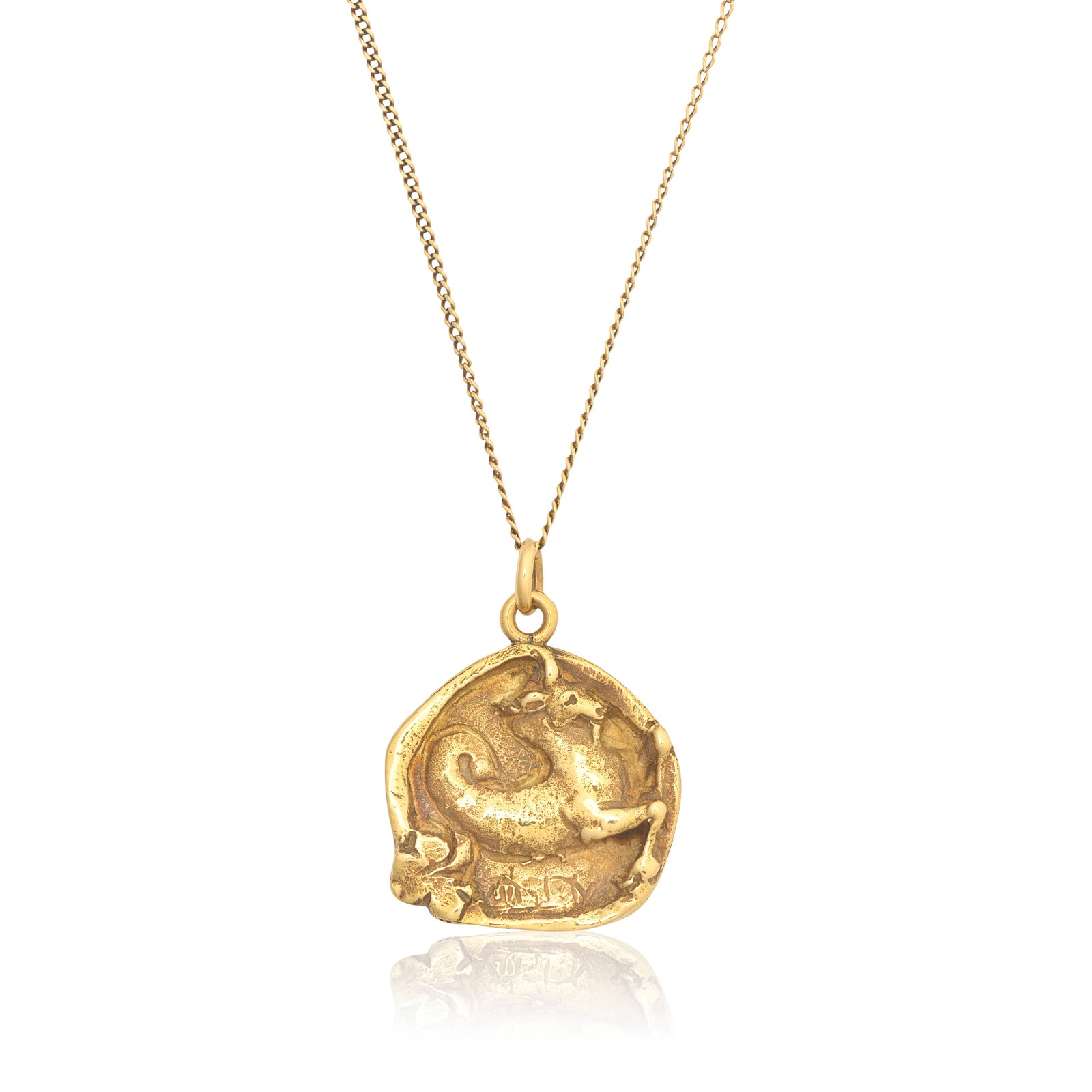 CARTIER: ZODIAC PENDANT, 1976: CARTIER: ZODIAC PENDANT, 1976 The 18 carat gold pendant depicting a ram, raised in relief, representing the zodiac symbol for Aries, suspended from an unassociated gold tracelink chain, pendant