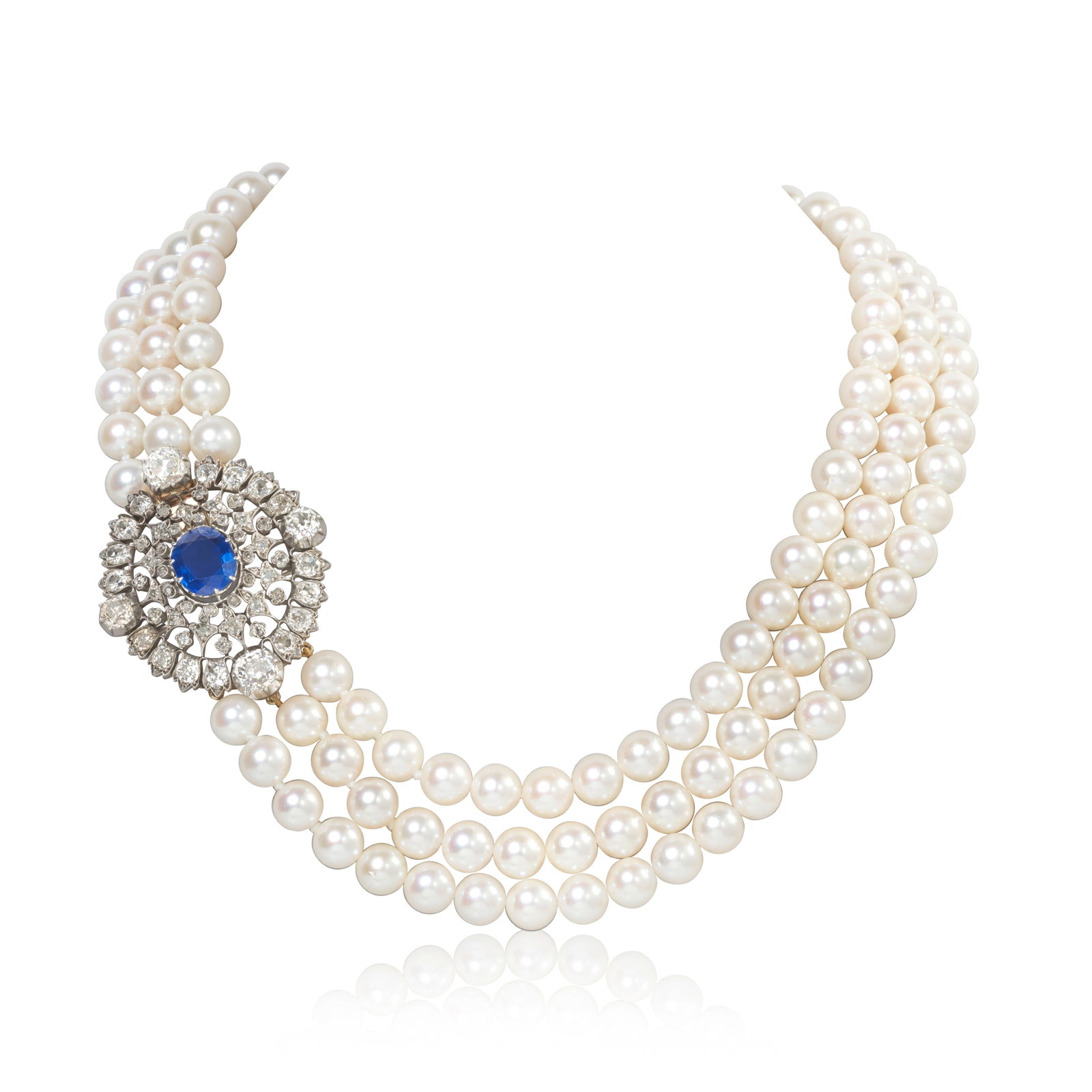 CULTURED PEARL, SAPPHIRE AND DIAMOND NECKLACE: CULTURED PEARL, SAPPHIRE AND DIAMOND NECKLACE The three strands of 8.0mm cultured pearls, on a pierced clasp radiating with foliate motifs, set throughout with old brilliant, old cushion and rose-cut 