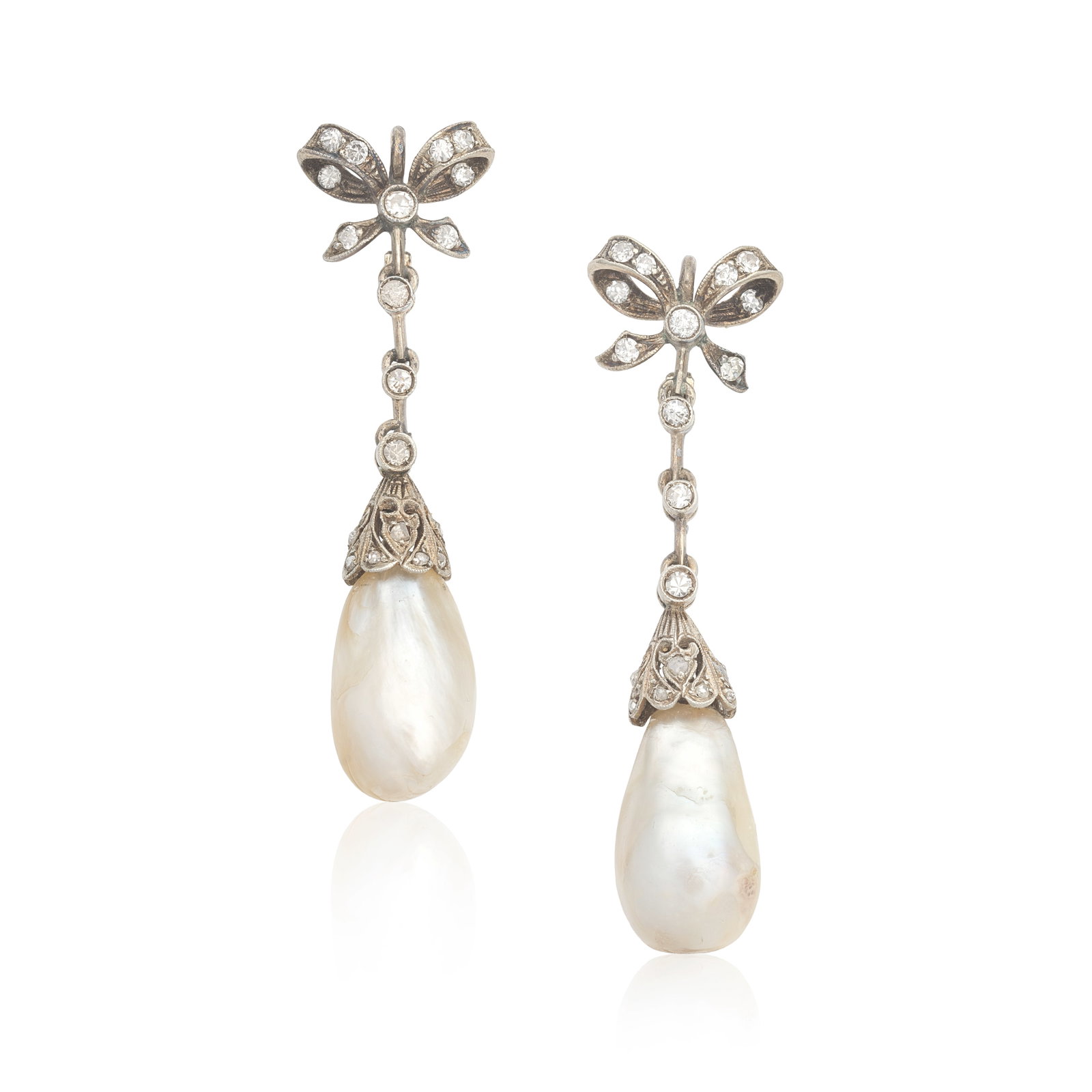 NATURAL PEARL AND DIAMOND EARRINGS: NATURAL PEARL AND DIAMOND EARRINGS Each single-cut diamond bow surmount issuing a baroque drop-shaped natural pearl via knifewire linking, length 4.4cm Footnotes: SSEF: One pearl half-drilled, one