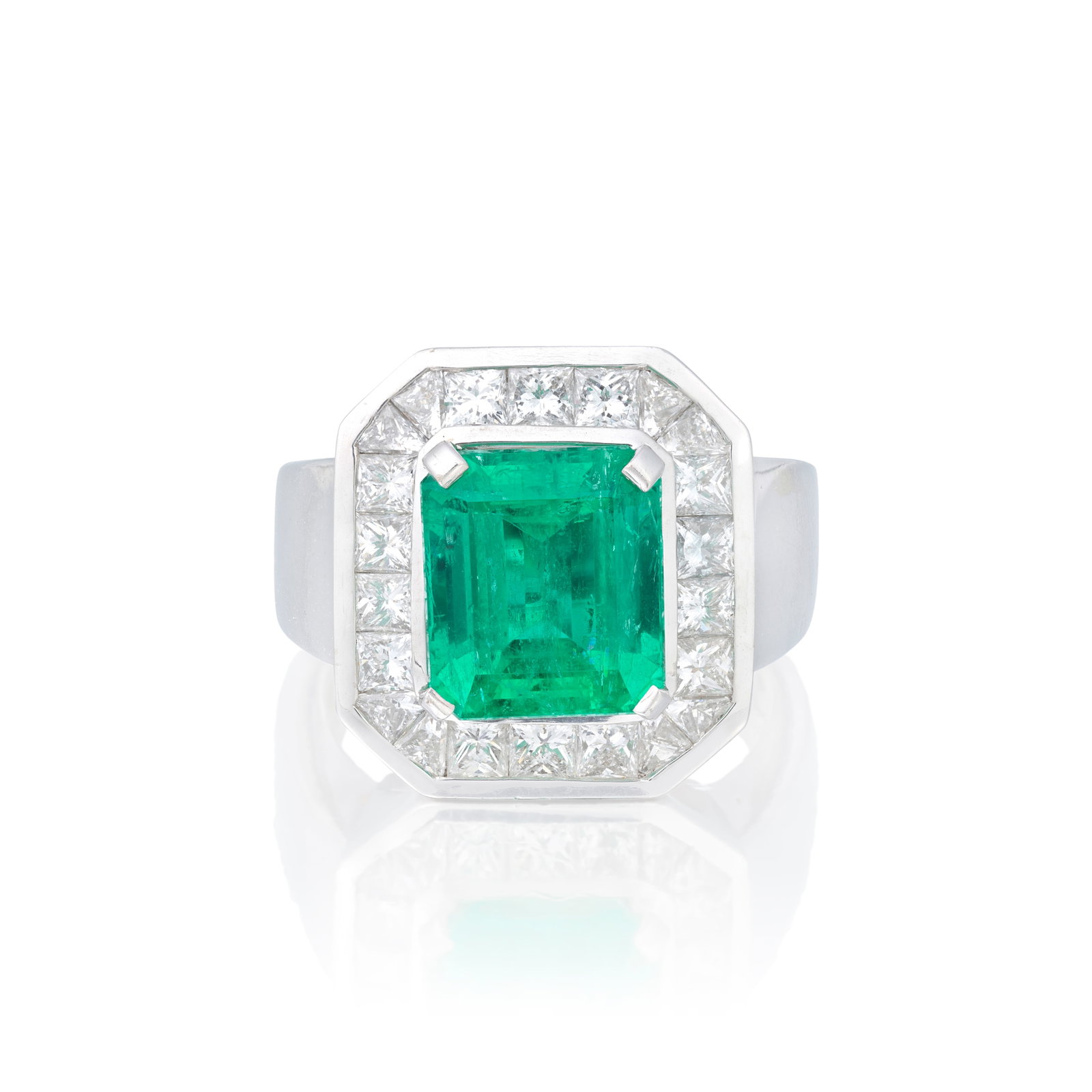EMERALD AND DIAMOND CLUSTER RING: EMERALD AND DIAMOND CLUSTER RING The step-cut emerald weighing 5.79 carats, within a surround of princess and calibré-cut diamonds, ring size approx. R½ For further information on this lot
