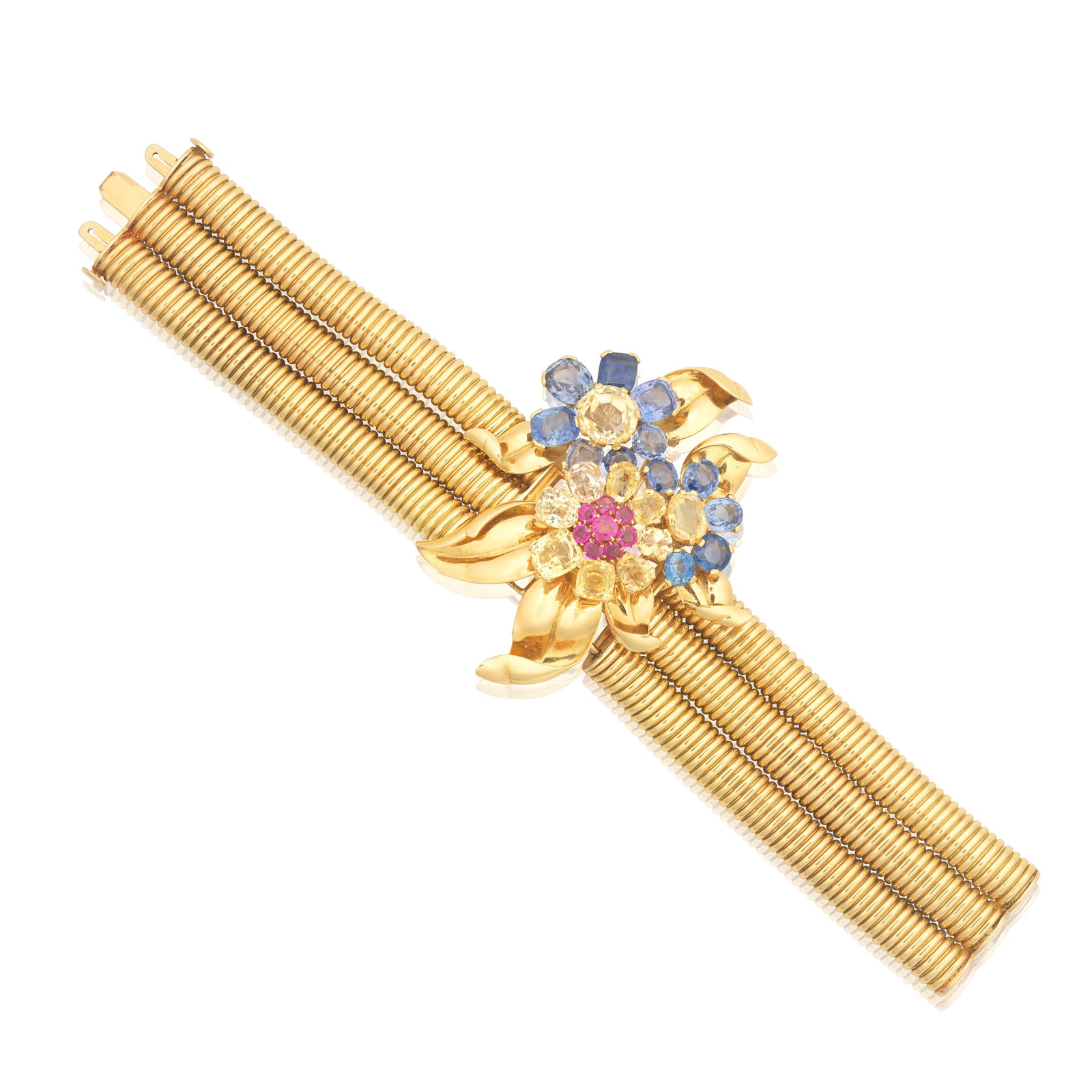 SAPPHIRE AND RUBY-SET FLOWER CLIP/BRACELET COMBINATION, CIRCA 1945: SAPPHIRE AND RUBY-SET FLOWER CLIP/BRACELET COMBINATION, CIRCA 1945 The trio of flowerheads issuing petals set with cushion and oval-cut blue and yellow sapphires, accented by a cluster of circular-cut