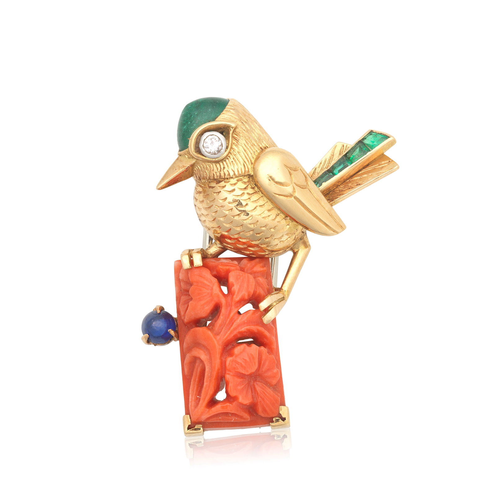 CARTIER: DIAMOND AND GEM-SET BIRD CLIP, CIRCA 1950s: CARTIER: DIAMOND AND GEM-SET BIRD CLIP, CIRCA 1950s Modelled as a bird perched on a carved coral corallium rubrum branch, the body with fine engraved detail throughout, the head set with an emerald