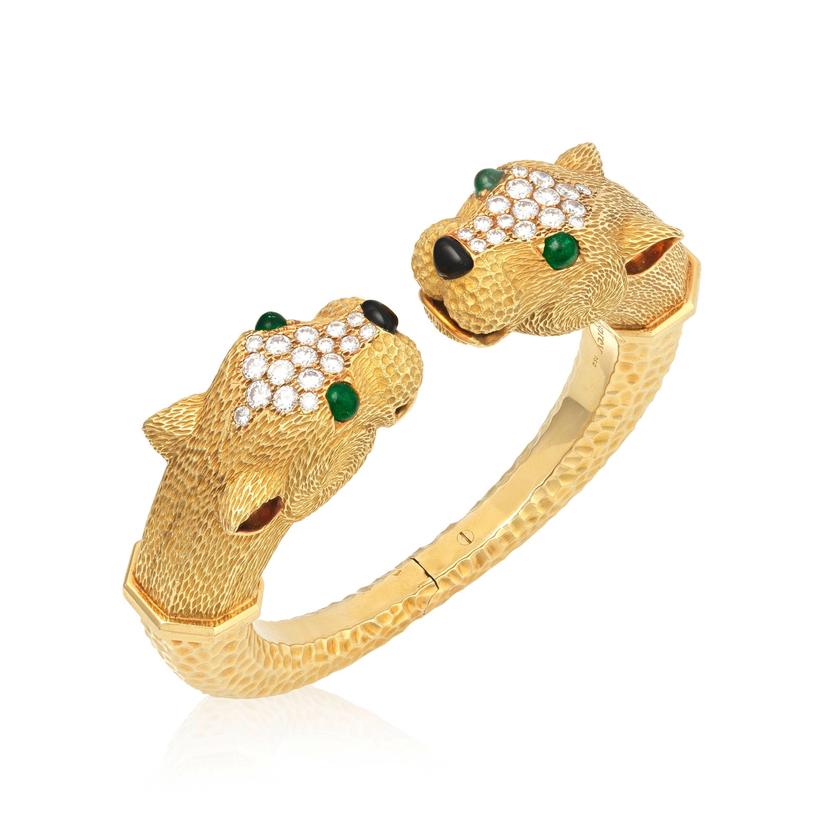 ASPREY: DIAMOND AND GEM-SET PANTHER BANGLE: ASPREY: DIAMOND AND GEM-SET PANTHER BANGLE The hinged bangle of hammered finish, terminating with realistically modelled and highly textured panther heads, issuing from polished collars, accented by