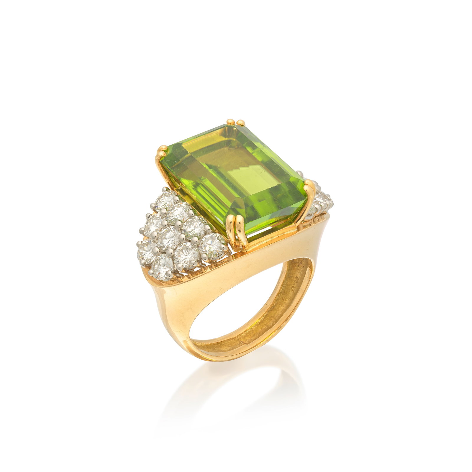PERIDOT AND DIAMOND RING: PERIDOT AND DIAMOND RING The step-cut peridot between brilliant-cut diamond shoulders, peridot approx. 13.90cts, diamonds approx. 2.70cts total, ring size approx. Q½ For further information on