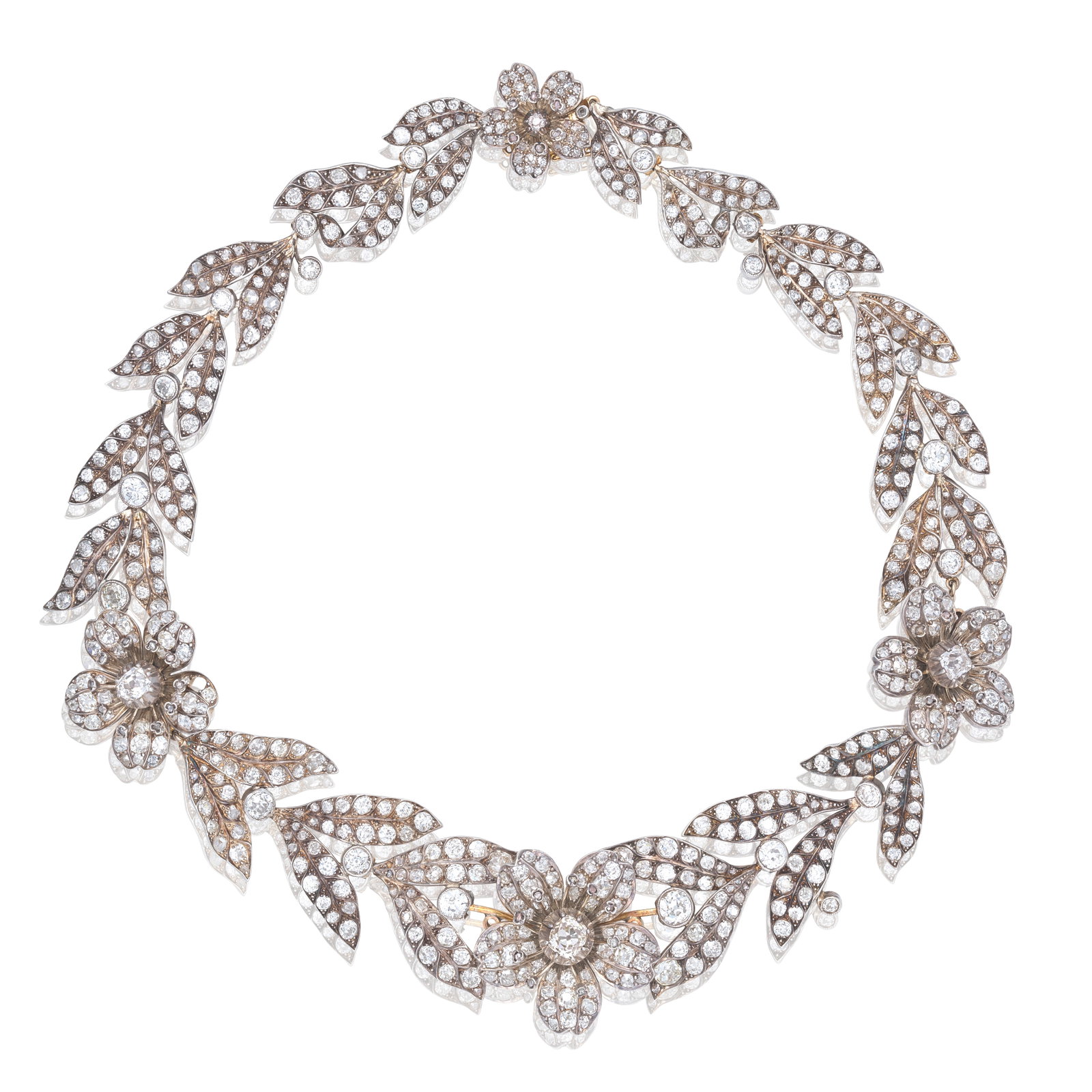 DIAMOND TIARA/NECKLACE/BROOCH/EARCLIP COMBINATION (7): DIAMOND TIARA/NECKLACE/BROOCH/EARCLIP COMBINATION Of floral and foliate motifs, set throughout with old cushion, old brilliant and rose-cut diamonds, the central flower detaching to form a brooch,