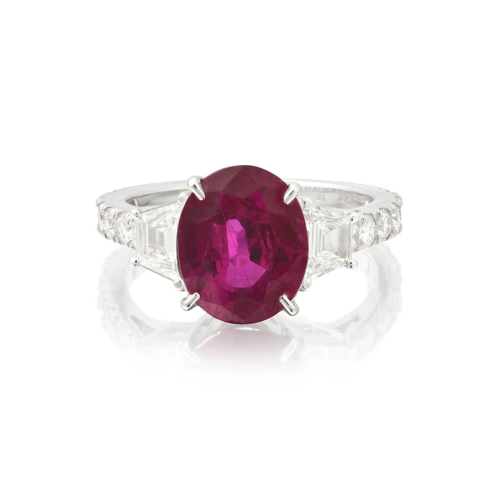 RUBY AND DIAMOND RING: RUBY AND DIAMOND RING The oval-cut ruby set between fancy and brilliant-cut diamond shoulders, ring size approx. K½ Footnotes: GCS: For further information, please refer to department. For