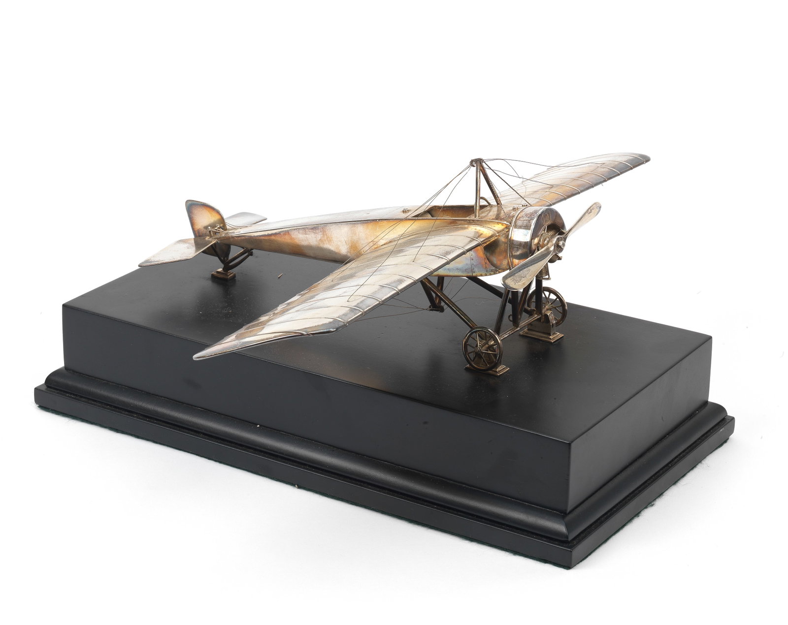 A silver model of a Moraine-Saunier Type H monoplane by Mappin & Webb, London, 1915,: A silver model of a Moraine-Saunier Type H monoplane by Mappin & Webb, London, 1915, finely detailed model, with clear hallmarks to left wing tip, approximately 1:24 scale, mounted on an ebonised base