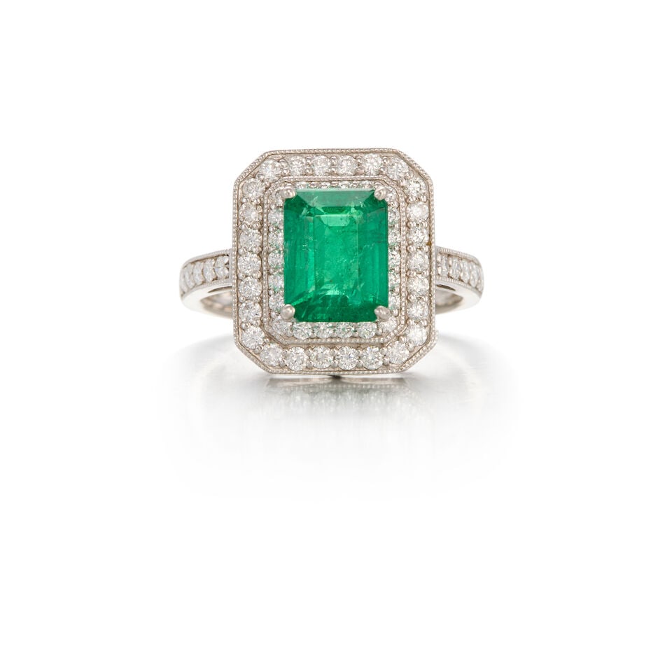 SHEFFIELD & SONS: PLATINUM, EMERALD, AND DIAMOND RING: SHEFFIELD & SONS: PLATINUM, EMERALD, AND DIAMOND RING • A rectangular shaped emerald weighing approximately 1.60 carats • Numerous round shaped diamonds weighing approximately 0.50 carat