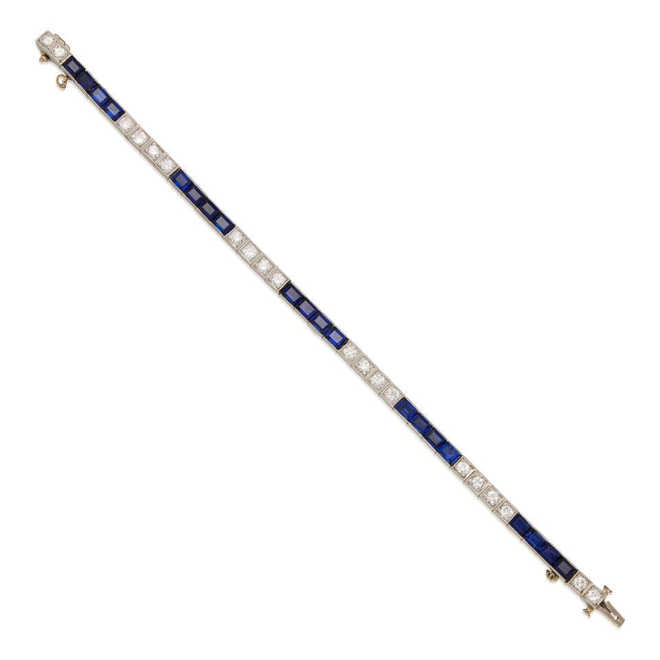 AN ART DECO 13K WHITE GOLD, SAPPHIRE, AND DIAMOND BRACELET: AN ART DECO 13K WHITE GOLD, SAPPHIRE, AND DIAMOND BRACELET • Twenty rectangular shaped sapphires weighing approximately 14 carats total • Twenty round shaped diamonds weighing