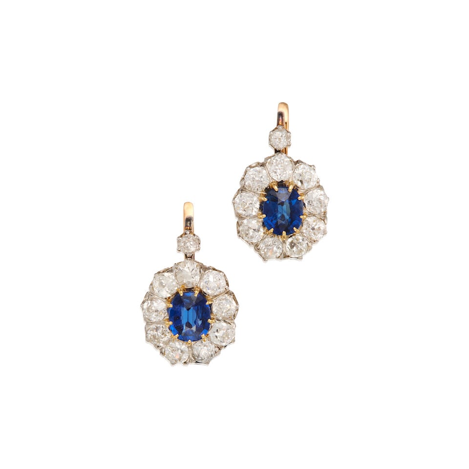A PAIR OF ANTIQUE SAPPHIRE AND DIAMOND EARRINGS: A PAIR OF ANTIQUE SAPPHIRE AND DIAMOND EARRINGS • Platinum, 6K and 18K yellow gold • Two oval shaped sapphires weighing approximately 1.65 carats total • Numerous old European cut di