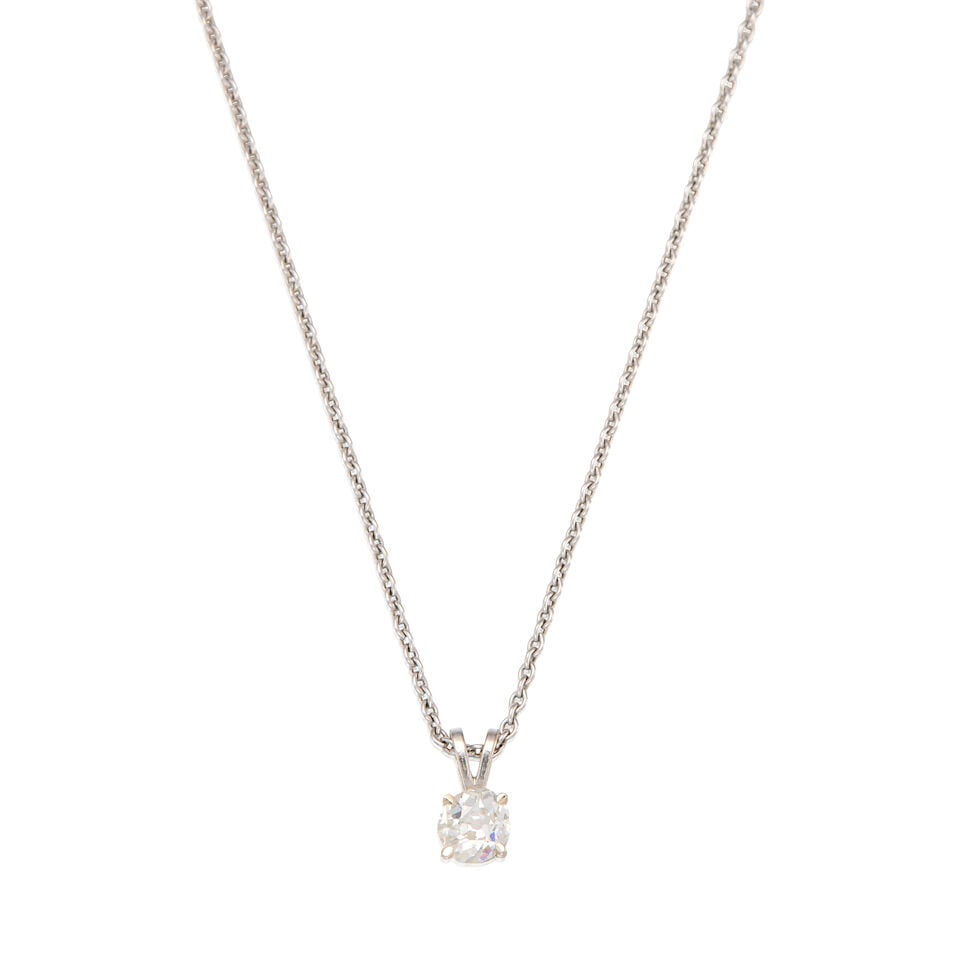 A GOLD AND DIAMOND PENDANT WITH CHAIN: A GOLD AND DIAMOND PENDANT WITH CHAIN • A 14K white gold pendant with one old mine-cut diamond weighing approximately 0.58 carat, measures 3/8 in. x 1/8 in. • A 14K white gold chain,