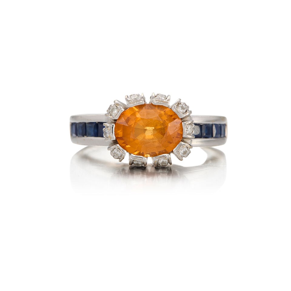 18K GOLD, CITRINE, SAPPHIRE, AND DIAMOND RING: 18K GOLD, CITRINE, SAPPHIRE, AND DIAMOND RING • One oval shaped citrine weighing approximately 1.40 carats total • Ten square shaped sapphires weighing approximately 0.30 carat