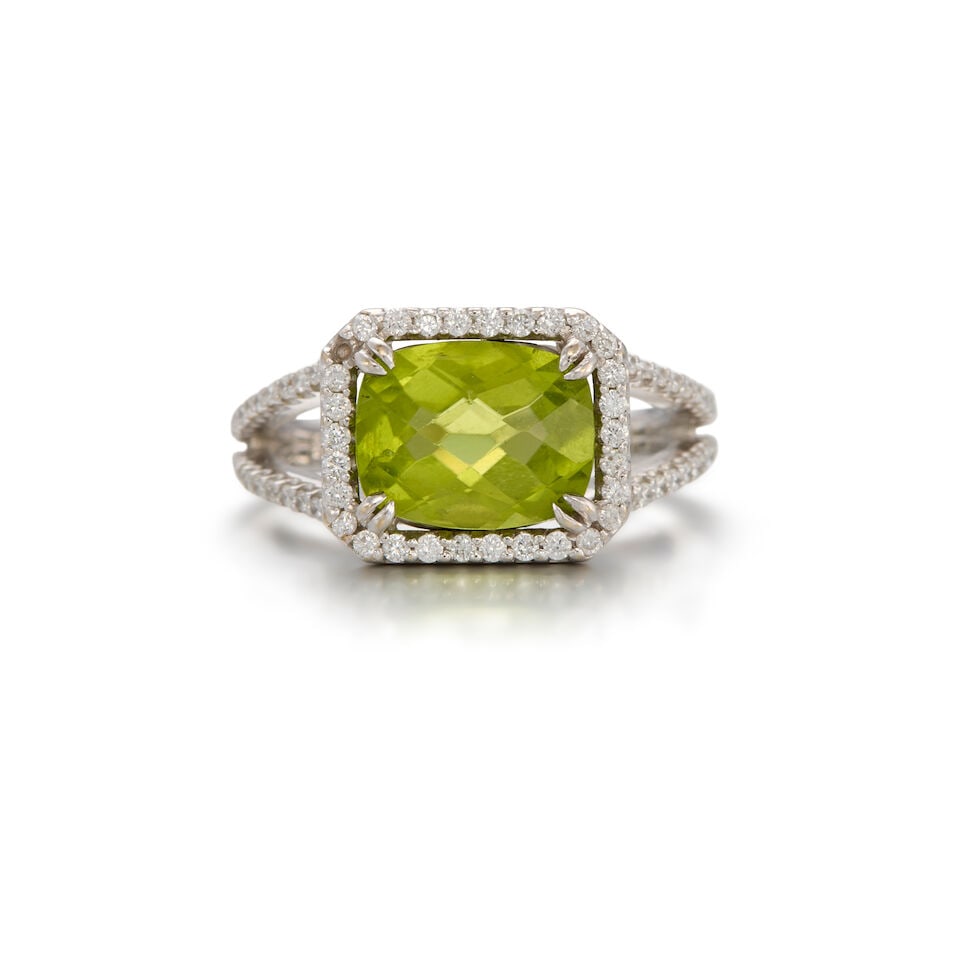 18K WHITE GOLD, PERIDOT, AND DIAMOND RING: 18K WHITE GOLD, PERIDOT, AND DIAMOND RING • One rectangular shaped peridot weighing approximately 2.50 carats total • Numerous round shaped diamonds weighing approximately 0.40 carat total