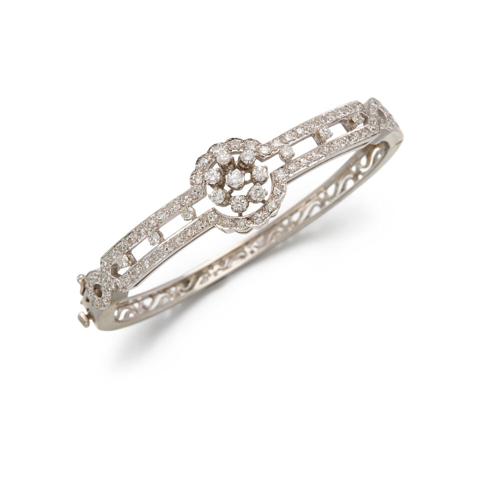 14K WHITE GOLD AND DIAMOND BANGLE: 14K WHITE GOLD AND DIAMOND BANGLE • Numerous round shaped diamonds weighing approximately 1.30 carats total • Inner circumference 6 1/2 in. • Estimated gross weight: 22.6