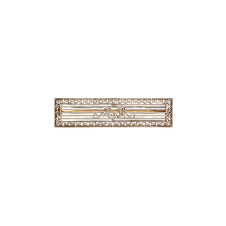 DREICER & CO: PLATINUM, GOLD, AND DIAMOND BROOCH: DREICER & CO: PLATINUM, GOLD, AND DIAMOND BROOCH • Platinum brooch and 14K yellow gold pin • Stamped DREICER & CO • Twelve round shaped melee diamonds • Measures 1 3/4 in. x
