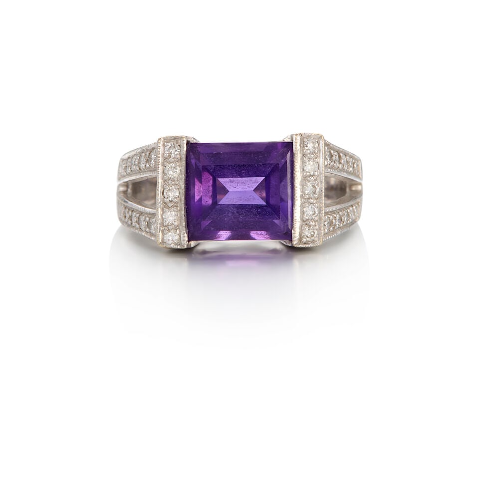 18K WHITE GOLD, AMETHYST, AND DIAMOND RING: 18K WHITE GOLD, AMETHYST, AND DIAMOND RING • A rectangular shaped amethyst weighing approximately 5.50 carats • Numerous round shaped diamonds weighing approximately 0.30 carats total R