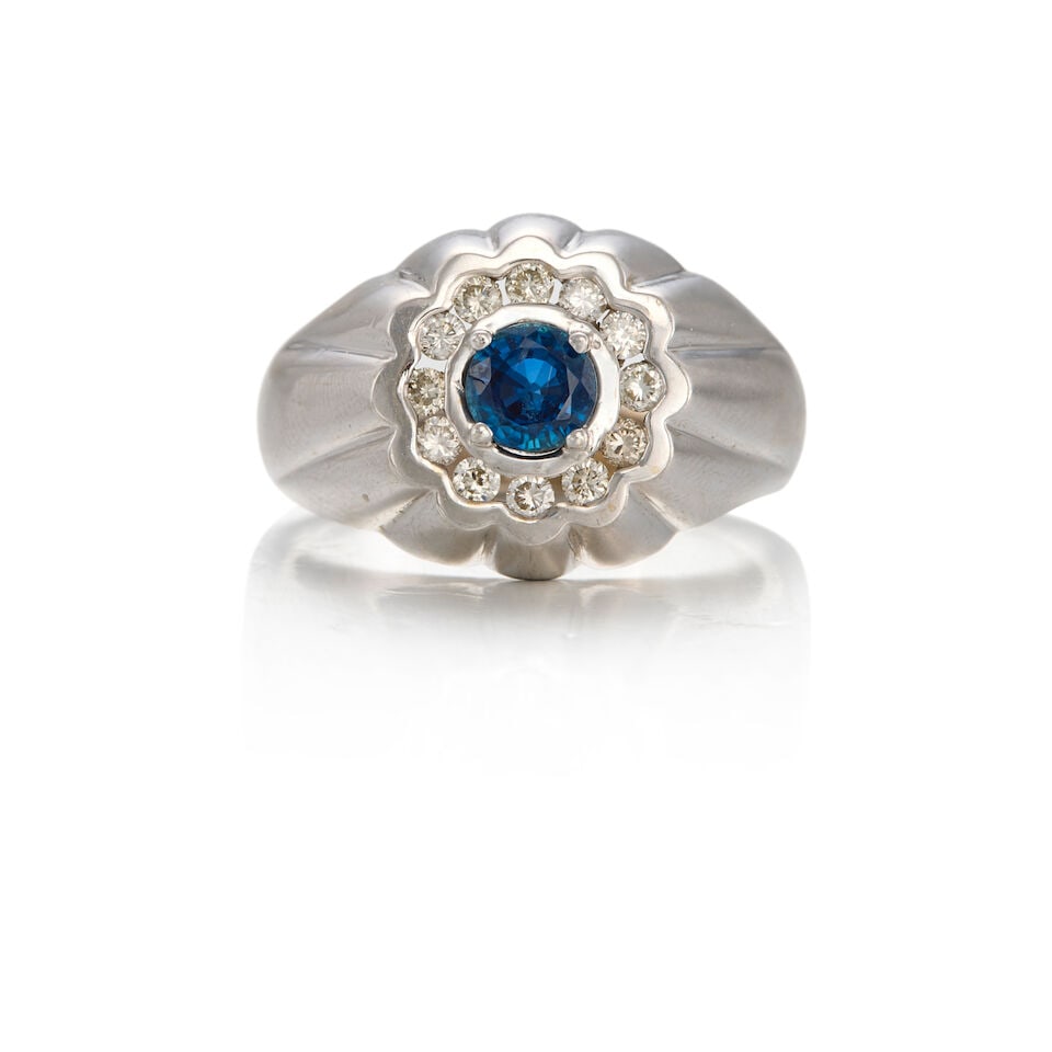 14K WHITE GOLD, SAPPHIRE, AND DIAMOND RING: 14K WHITE GOLD, SAPPHIRE, AND DIAMOND RING • One round shaped sapphire weighing approximately 0.45 carat total • Twelve round shaped diamonds weighing approximately 0.12 carat total