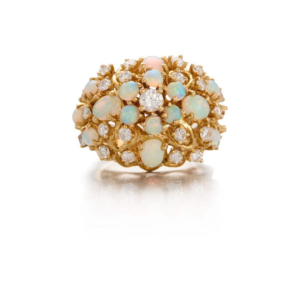 14K YELLOW GOLD, OPAL, AND DIAMOND RING: 14K YELLOW GOLD, OPAL, AND DIAMOND RING • Fifteen round and oval shaped opals measuring approximately 3.75mm in diameter to 6.40mm x 4.57mm • Numerous round shaped diamonds weighing