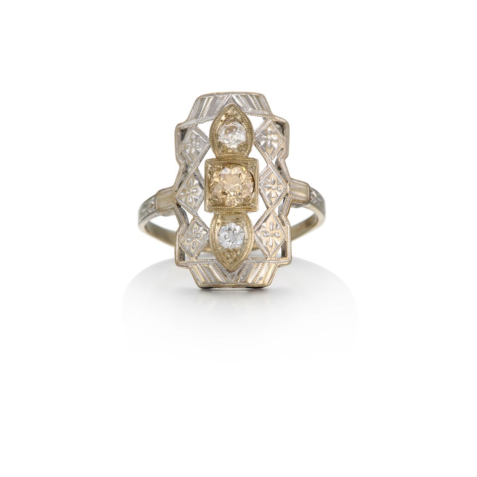 A 12K WHITE GOLD AND DIAMOND RING: A 12K WHITE GOLD AND DIAMOND RING • Three old European-cut diamonds weighing approximately 0.57 carats total • Size 7 1/4 • Estimated gross weight: 2.30 grams Footnotes: OVERALL