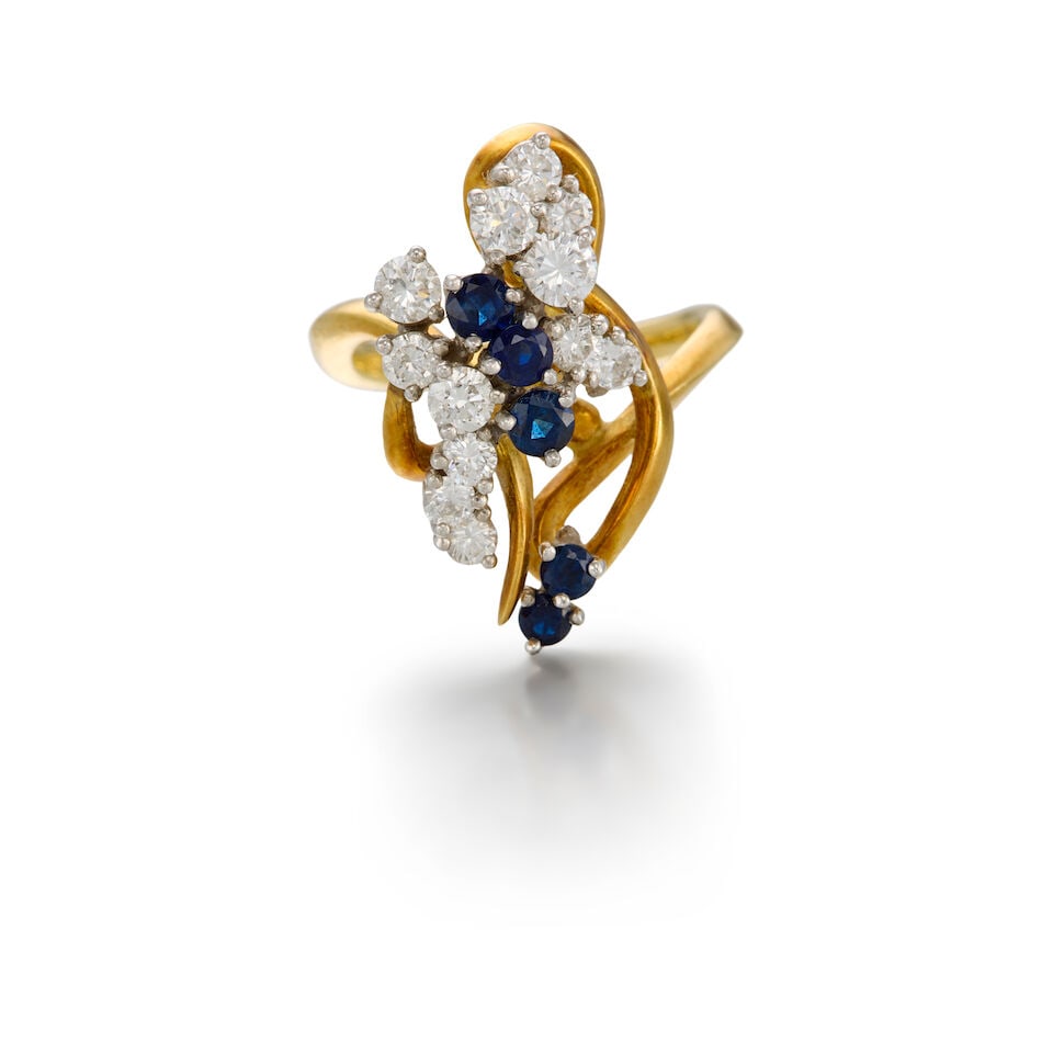 SAPPHIRE AND DIAMOND RING: SAPPHIRE AND DIAMOND RING • Platinum and 17K yellow gold • Five round-shaped sapphires weighing approximately 0.58 carat total • Twelve round brilliant-cut diamonds weighing